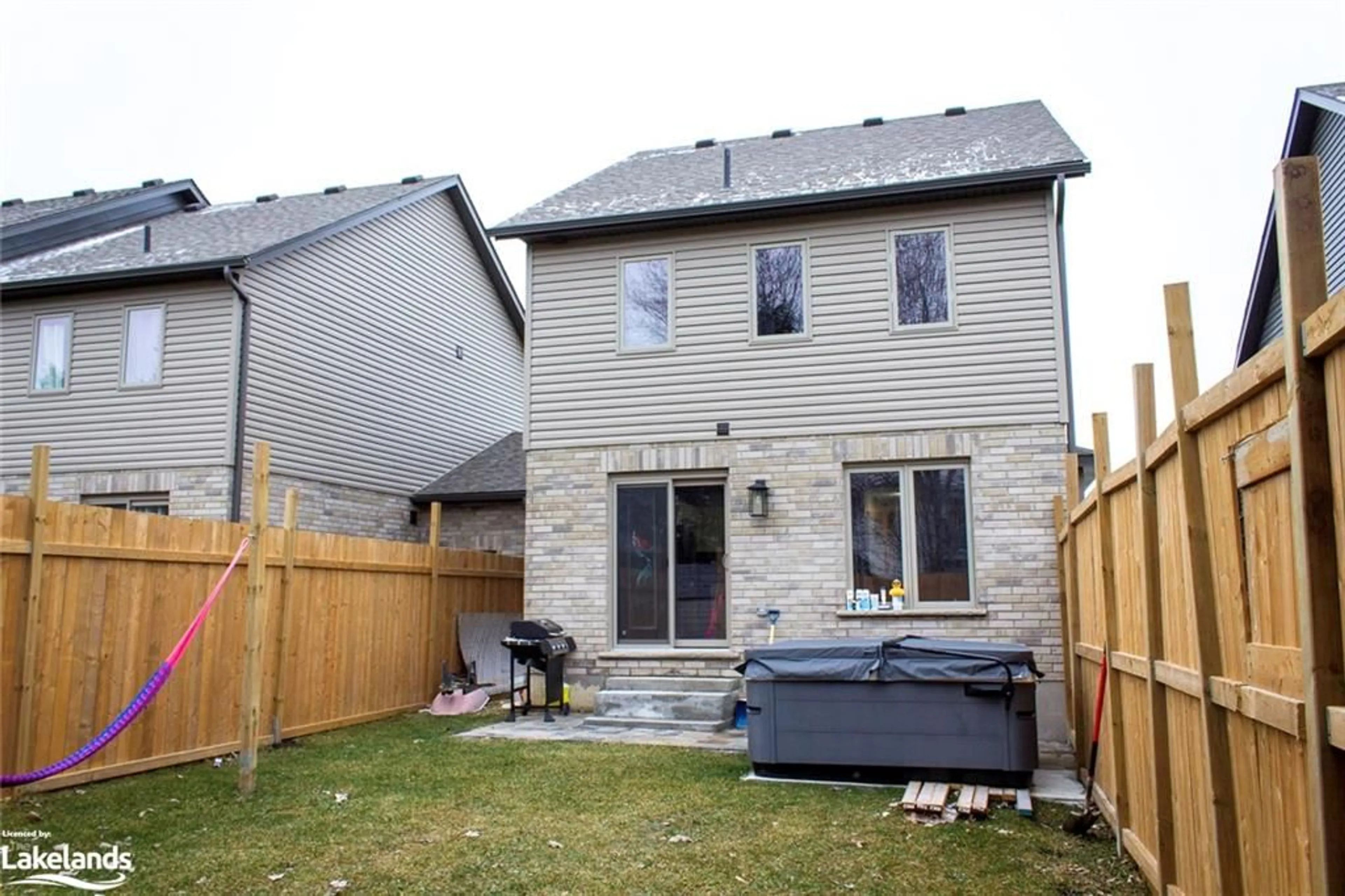 Frontside or backside of a home, the fenced backyard for 131 Stonebrook Way, Markdale Ontario N0C 1H0