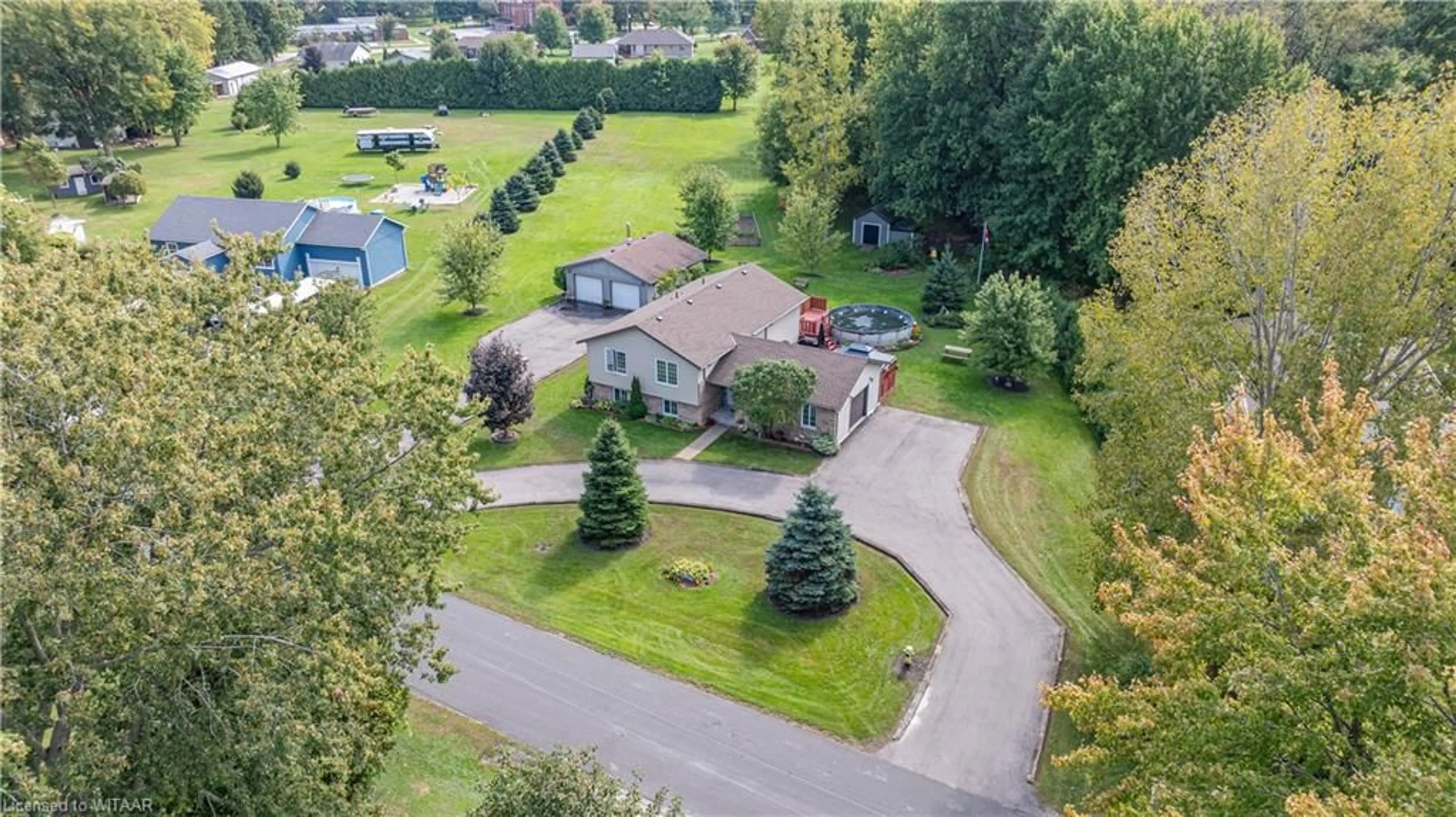 Frontside or backside of a home, the fenced backyard for 35 Adams St, Courtland Ontario N0J 1E0