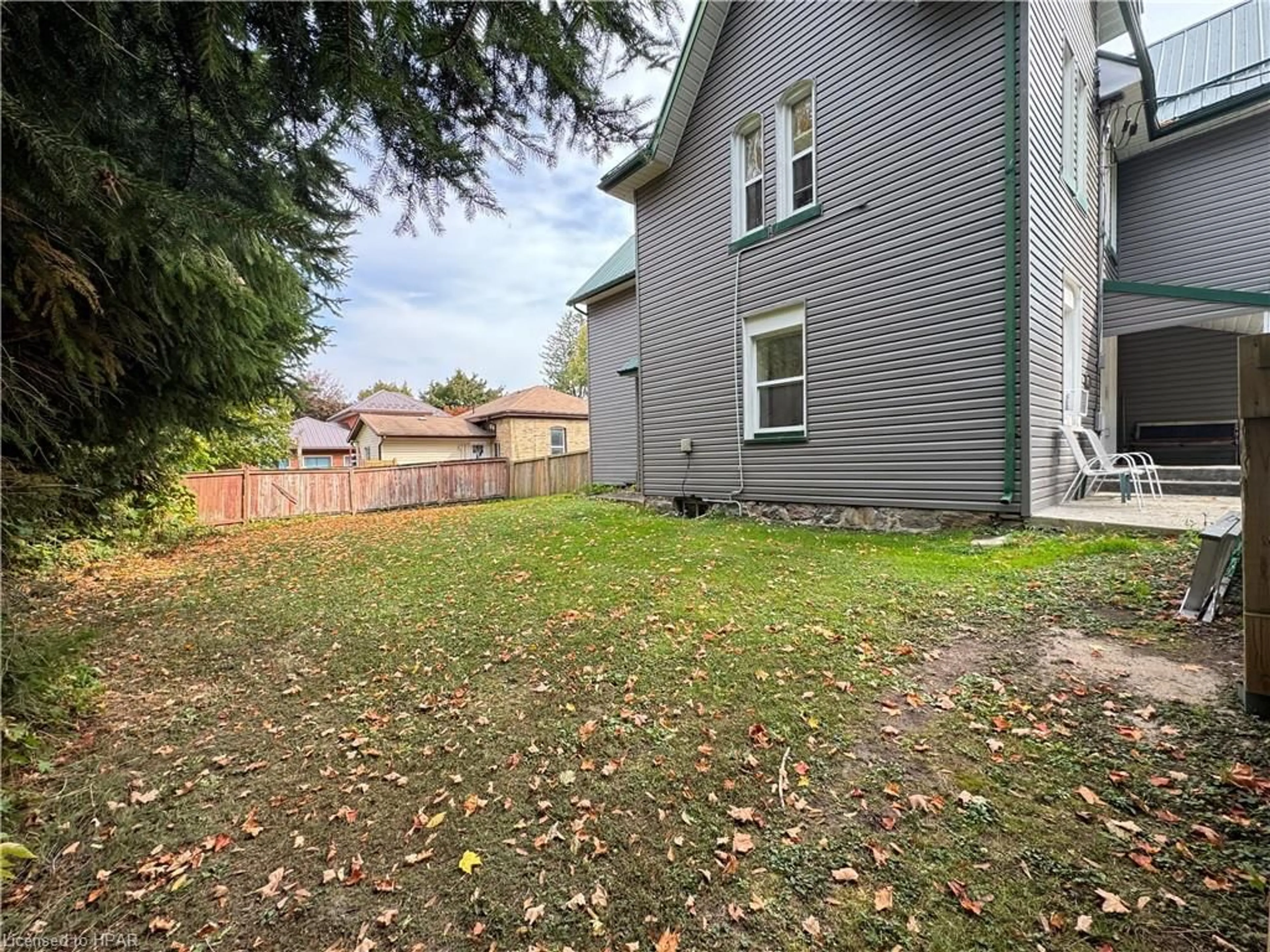 Frontside or backside of a home, the fenced backyard for 103 Patrick St, Wingham Ontario N0G 2W0