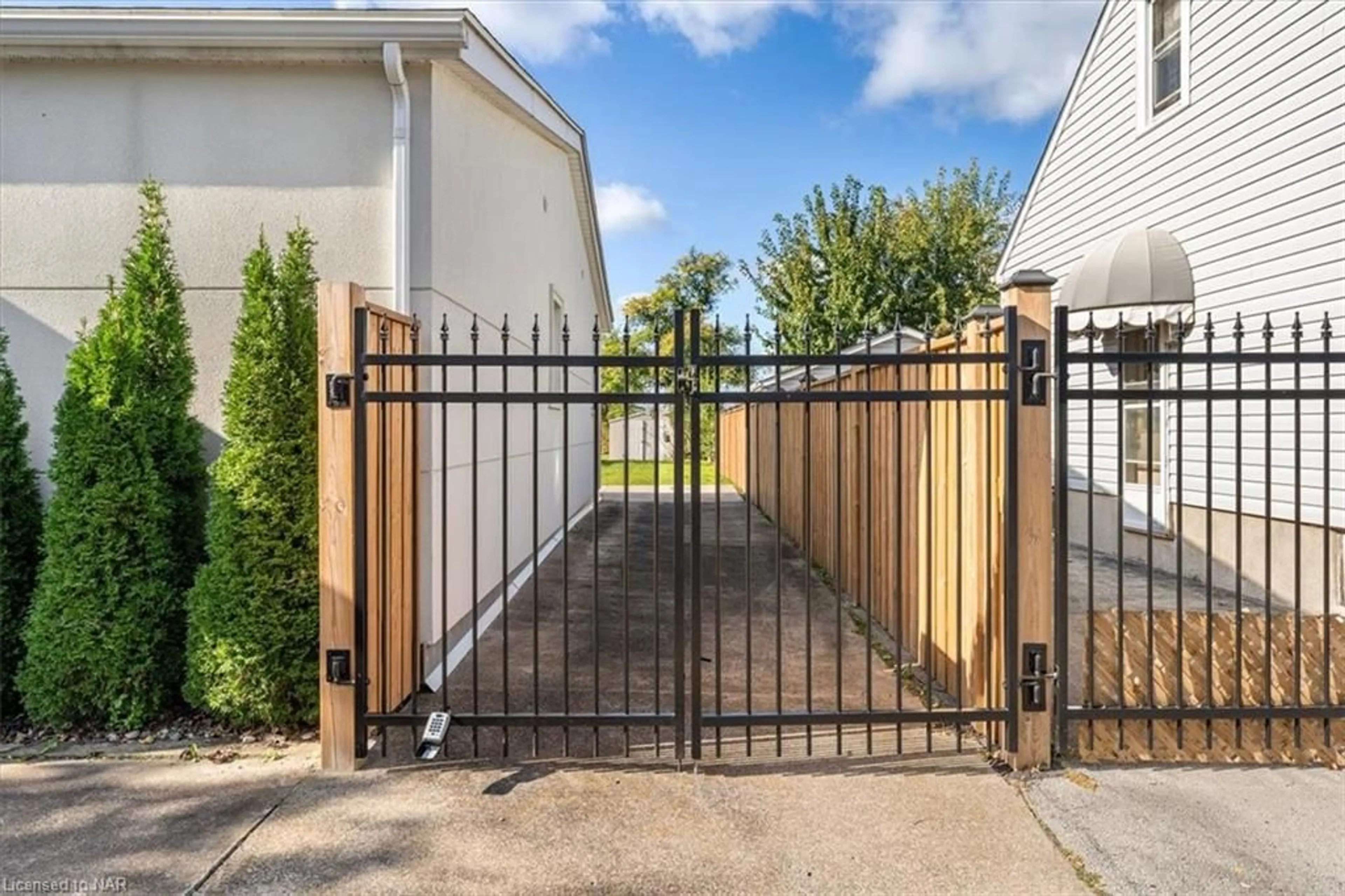 Frontside or backside of a home, the fenced backyard for 13 Ambrose St, St. Catharines Ontario L2S 2K6