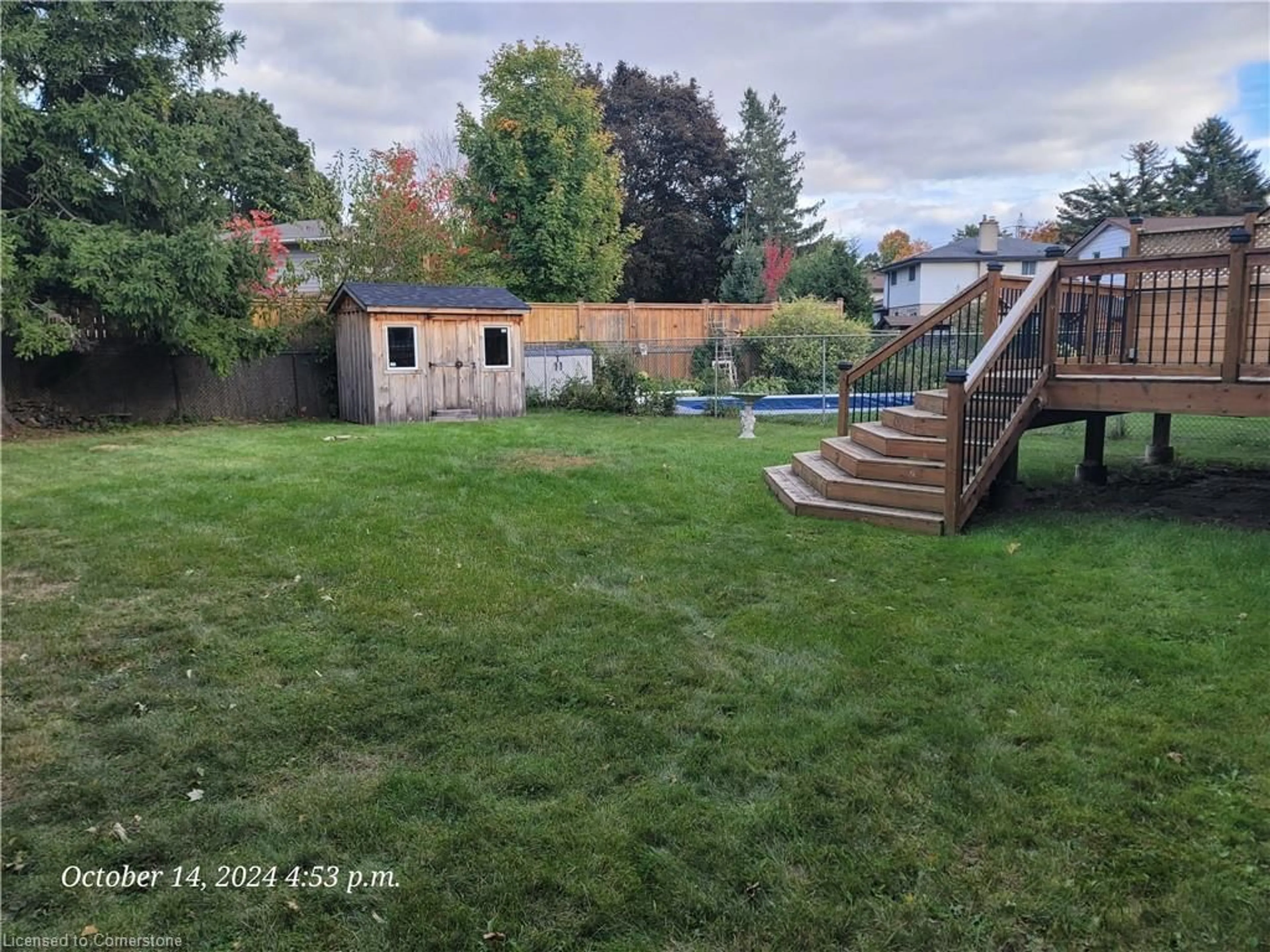 Frontside or backside of a home, the fenced backyard for 18 Dreger Ave, Kitchener Ontario N2A 2A3