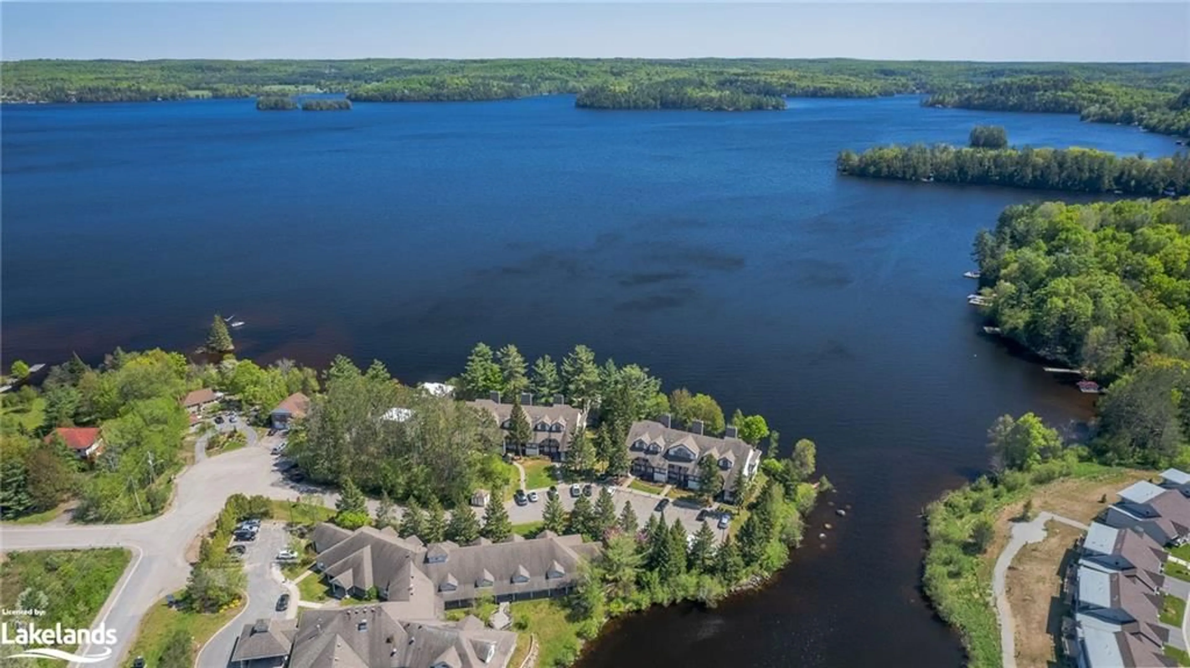 A pic from exterior of the house or condo, lake for 10 Coveside Dr #208, Huntsville Ontario P1H 1C3