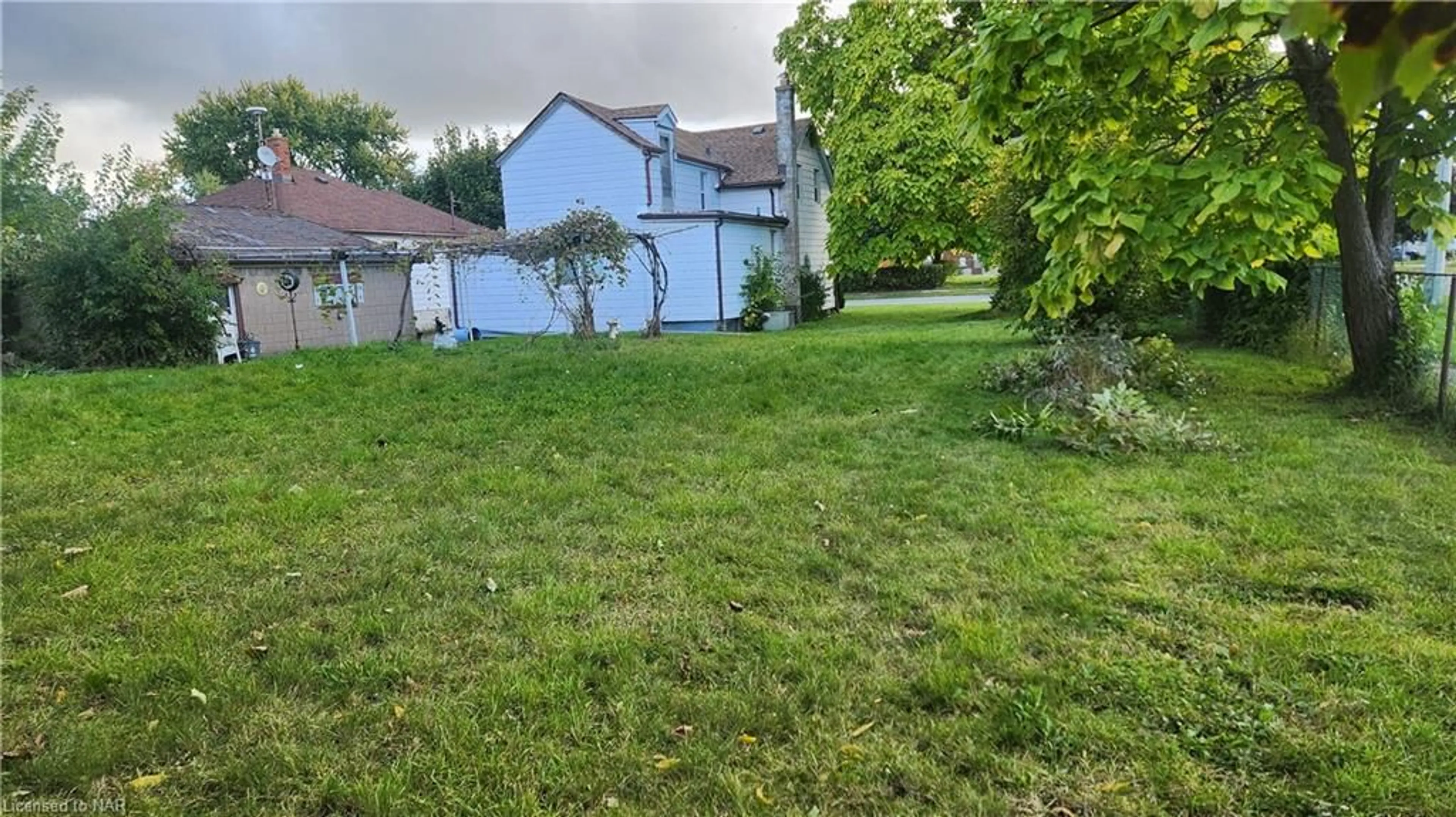 Frontside or backside of a home, the fenced backyard for 69 Queen St, Thorold Ontario L2V 3N4