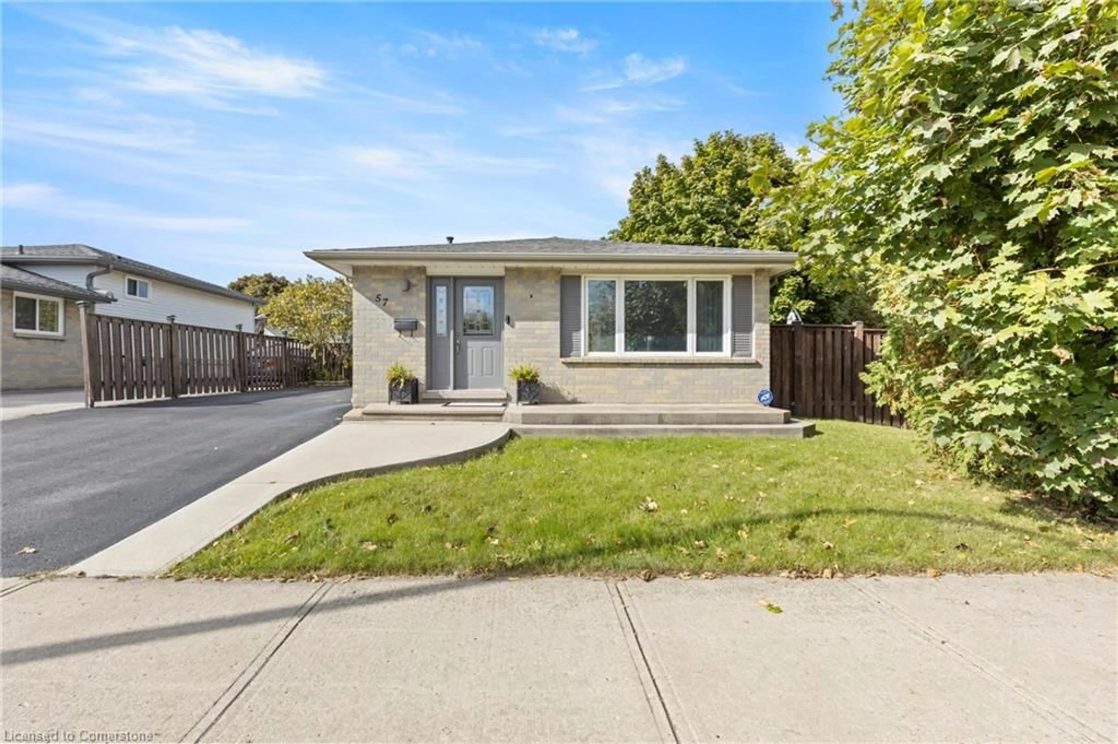 Frontside or backside of a home, the fenced backyard for 57 Odessa St, Stoney Creek Ontario L8J 1A3