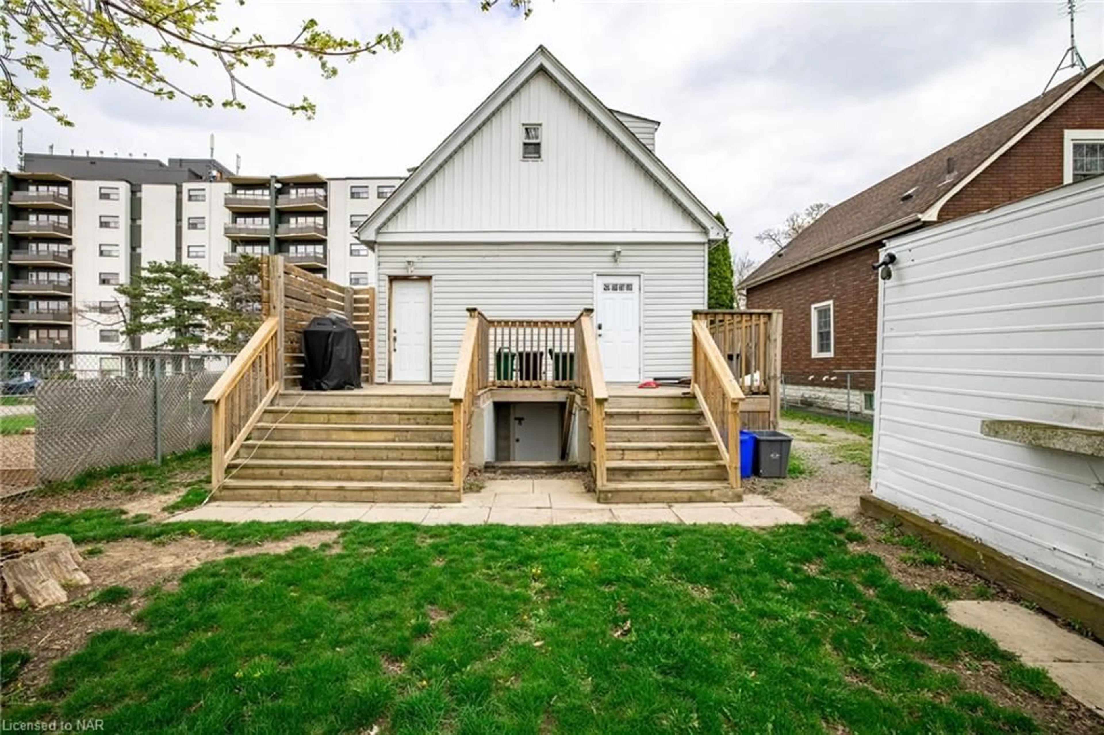 Frontside or backside of a home, the fenced backyard for 27 Ida St, St. Catharines Ontario L2R 3X2