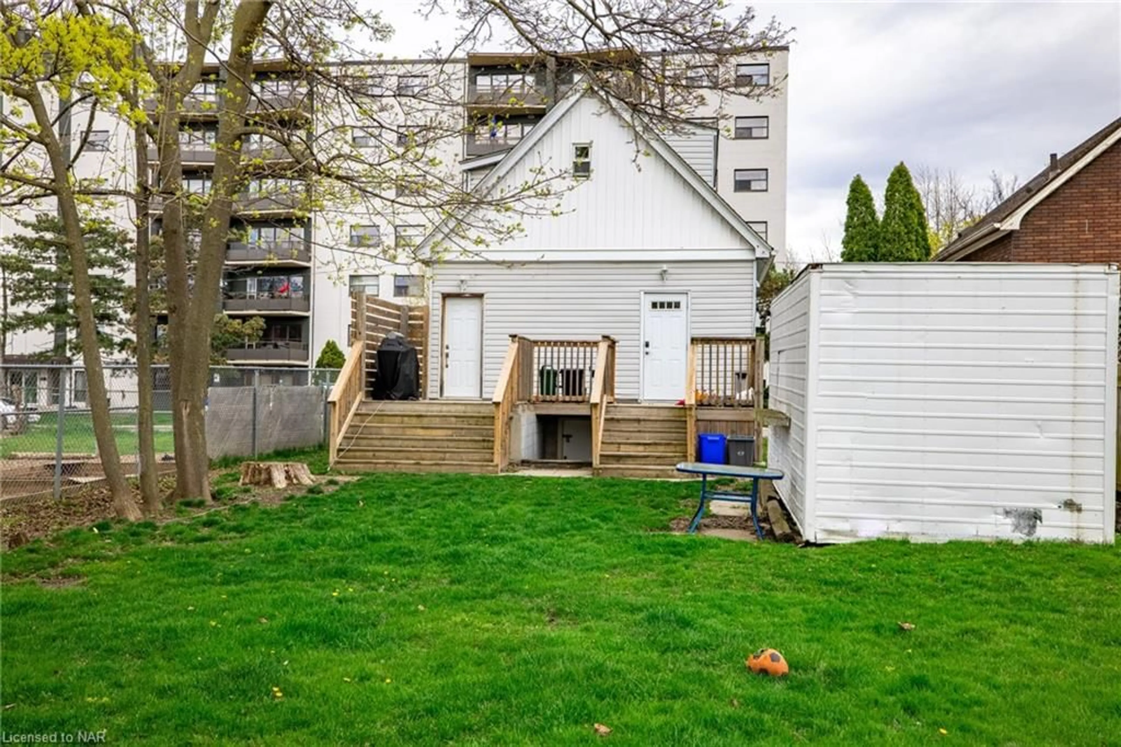 A pic from exterior of the house or condo, the fenced backyard for 27 Ida St, St. Catharines Ontario L2R 3X2