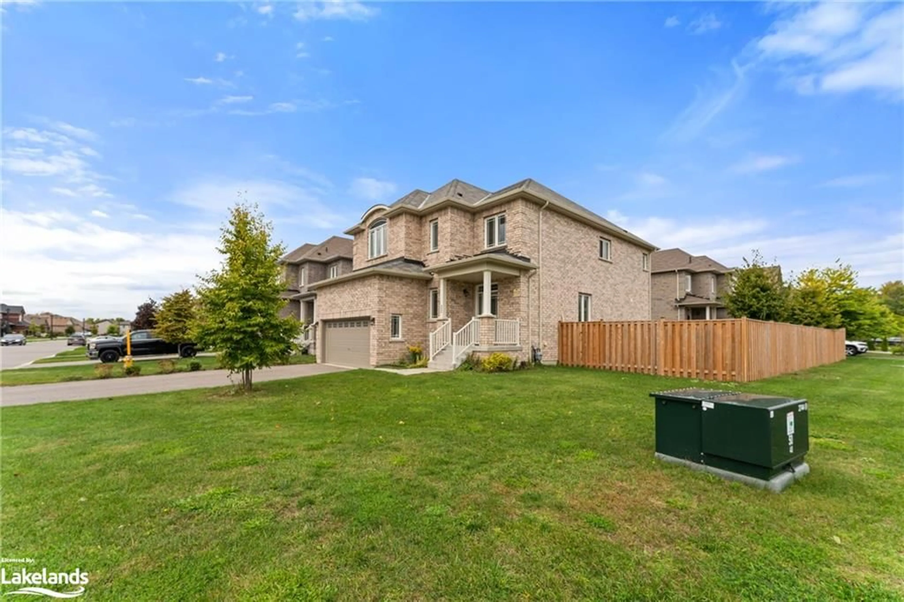 Frontside or backside of a home, the fenced backyard for 22 Pearl St, Wasaga Beach Ontario L9Z 0G9