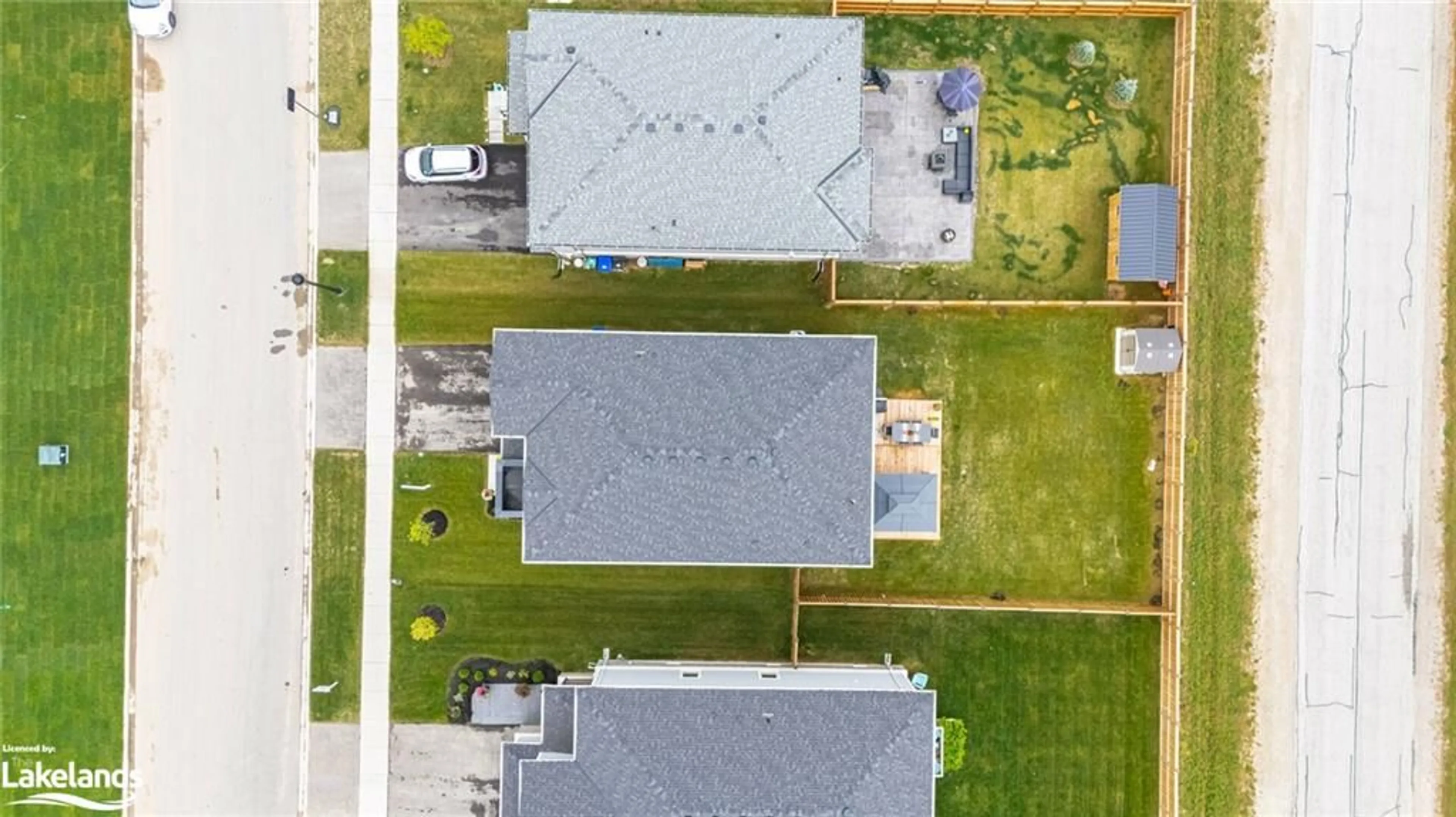 Frontside or backside of a home, the fenced backyard for 15 Autumn Dr, Wasaga Beach Ontario L9Z 0K7