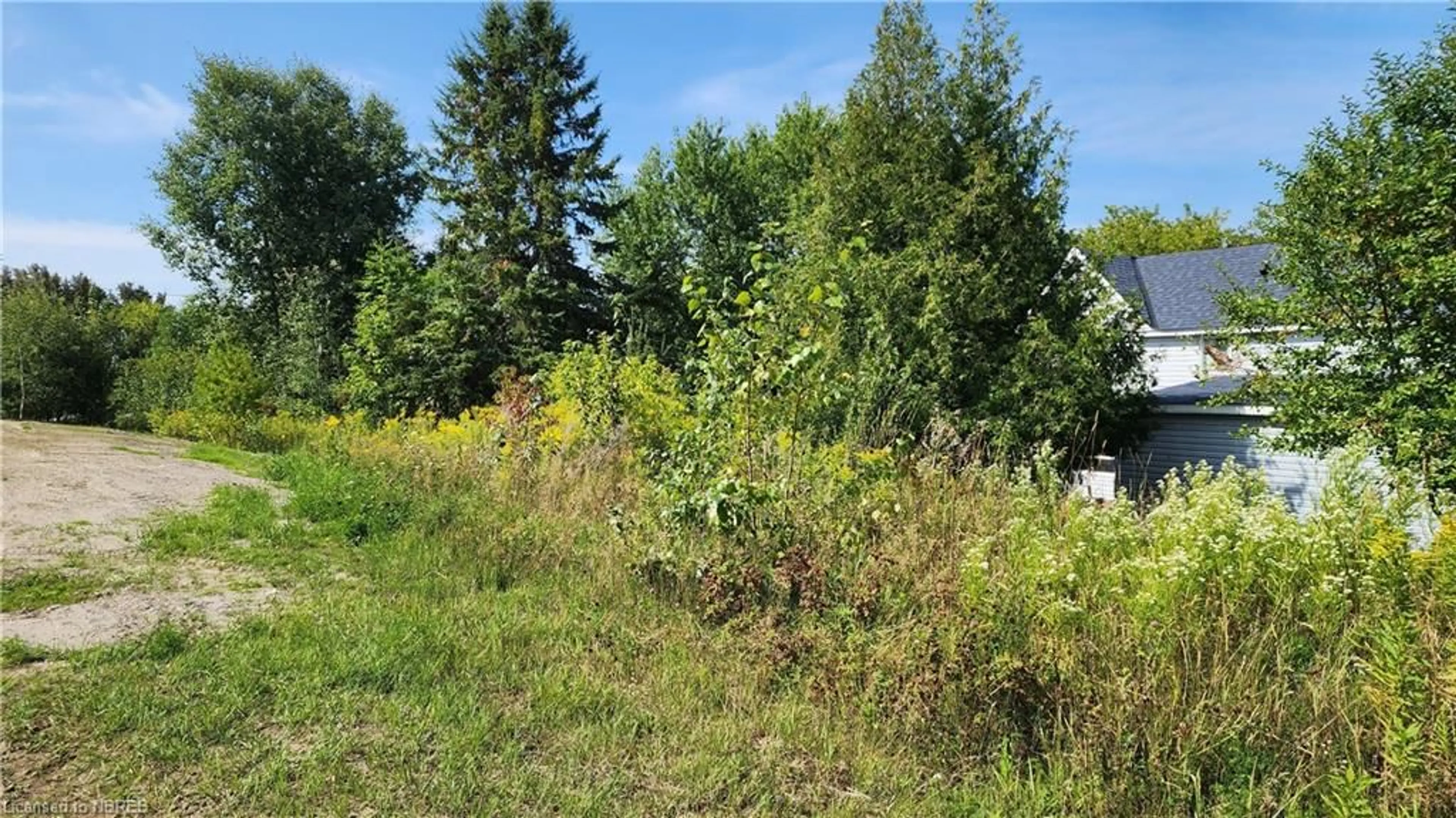 A pic from exterior of the house or condo, the fenced backyard for 14 Hay St, Cache Bay Ontario P0H 1G0