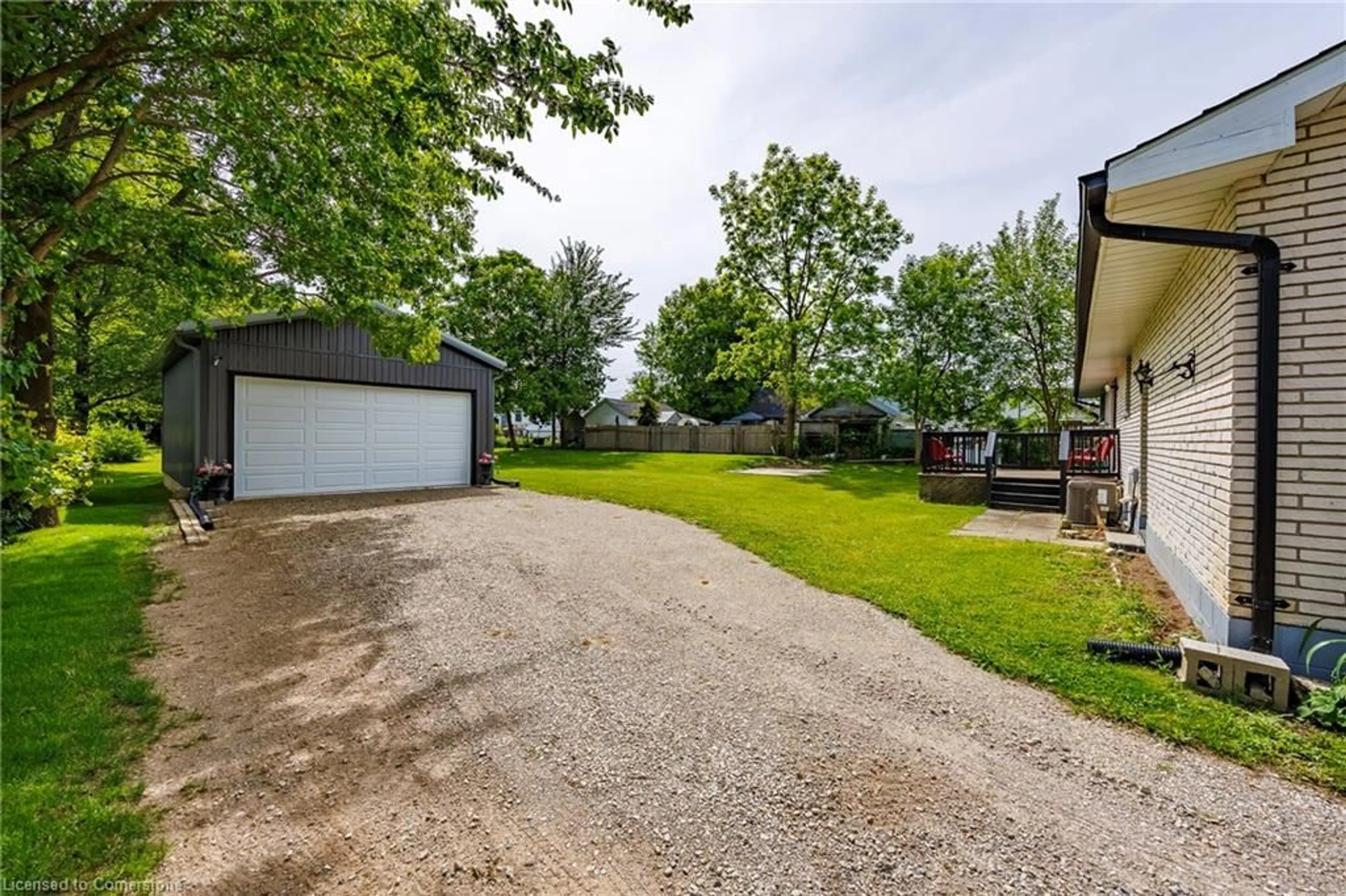 A pic from exterior of the house or condo, the fenced backyard for 551 East St, Delhi Ontario N4B 2J4