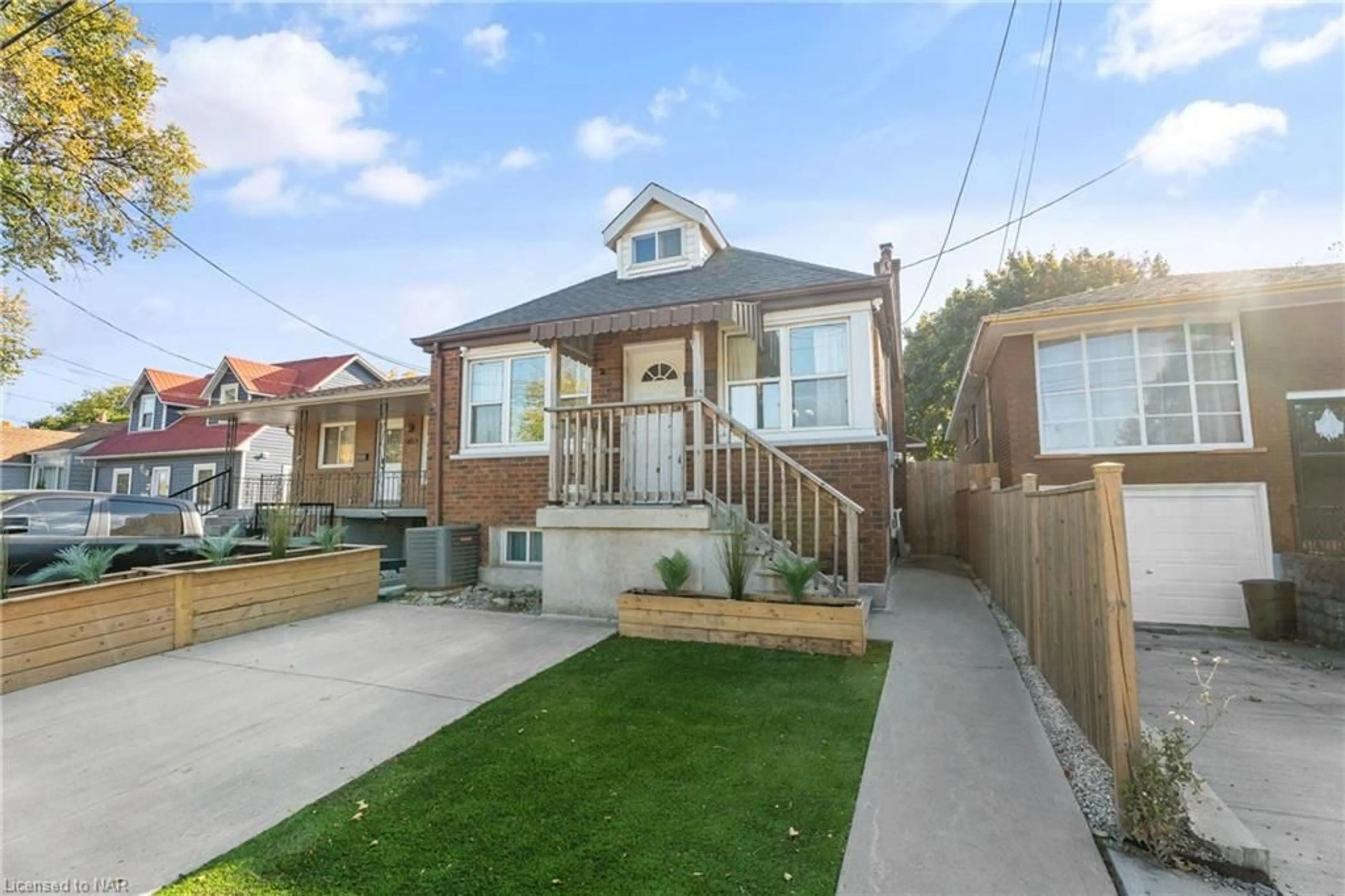 Frontside or backside of a home, the fenced backyard for 60 Merchison Ave, Hamilton Ontario L8H 3E1