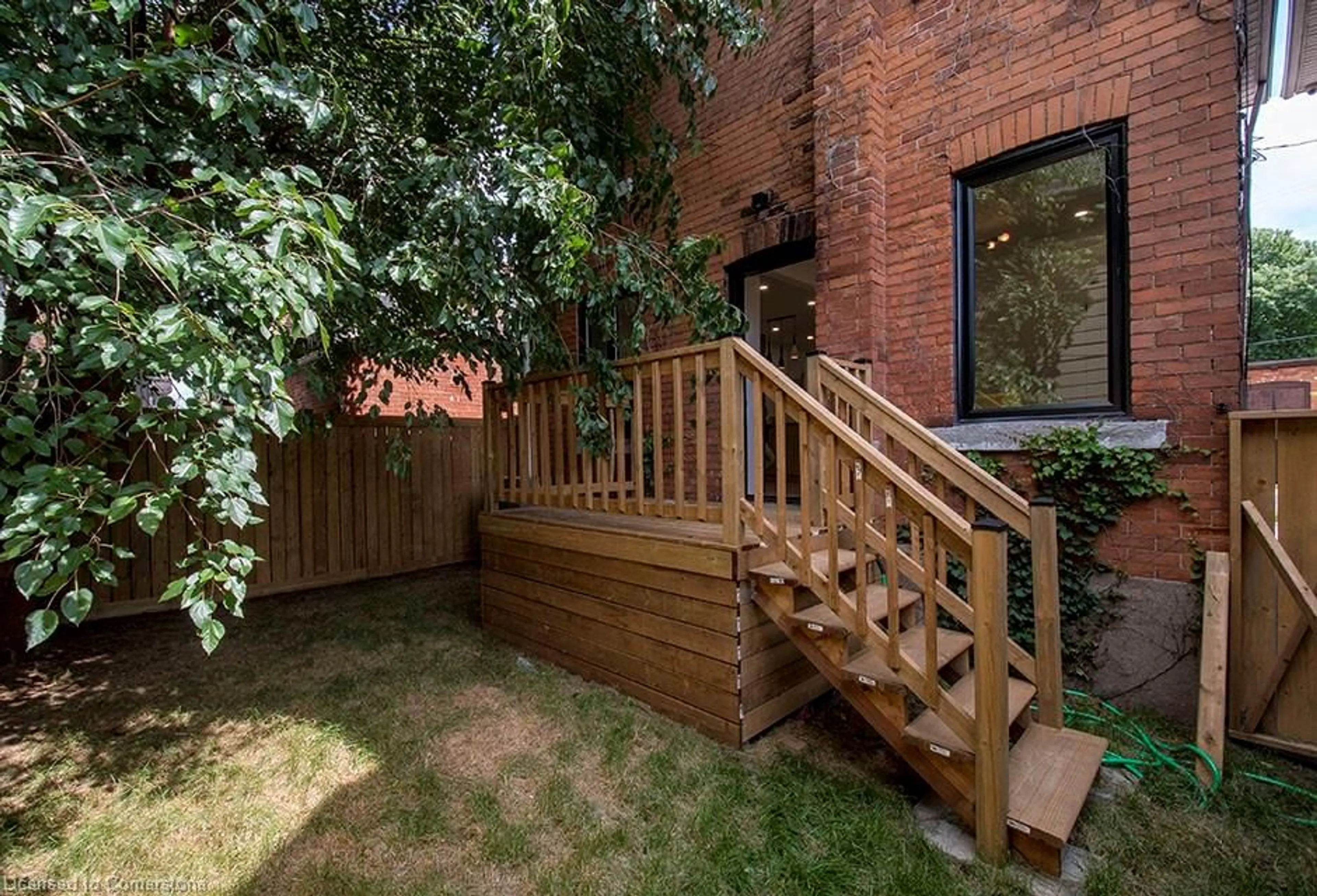 Patio, the fenced backyard for 48 Sanford Ave, Hamilton Ontario L8M 2G6