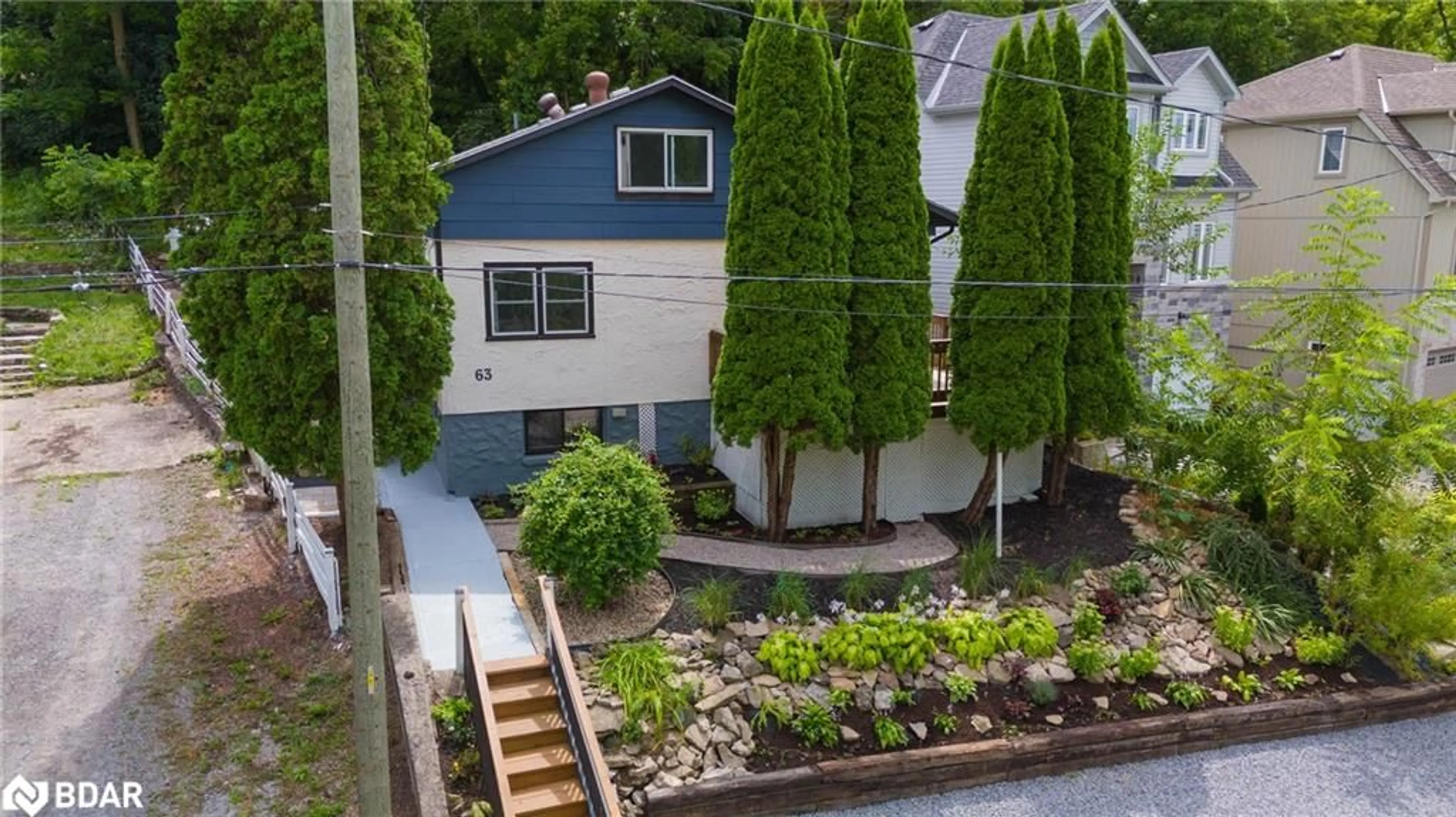 Frontside or backside of a home, the fenced backyard for 63 Bradley St, St. Catharines Ontario L2T 1R5