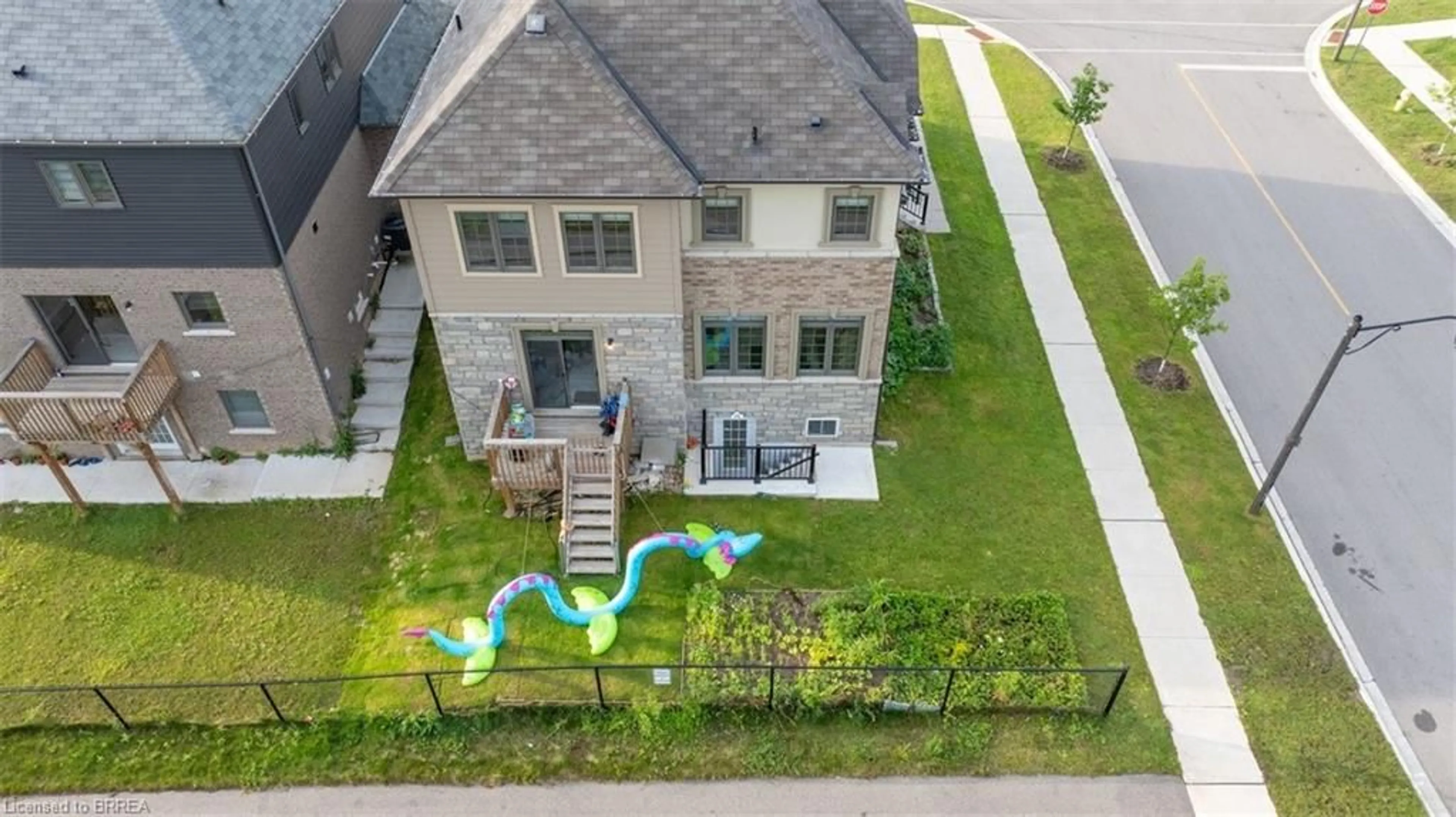 Frontside or backside of a home, the fenced backyard for 22 Sleeth St, Brantford Ontario N3S 0J7