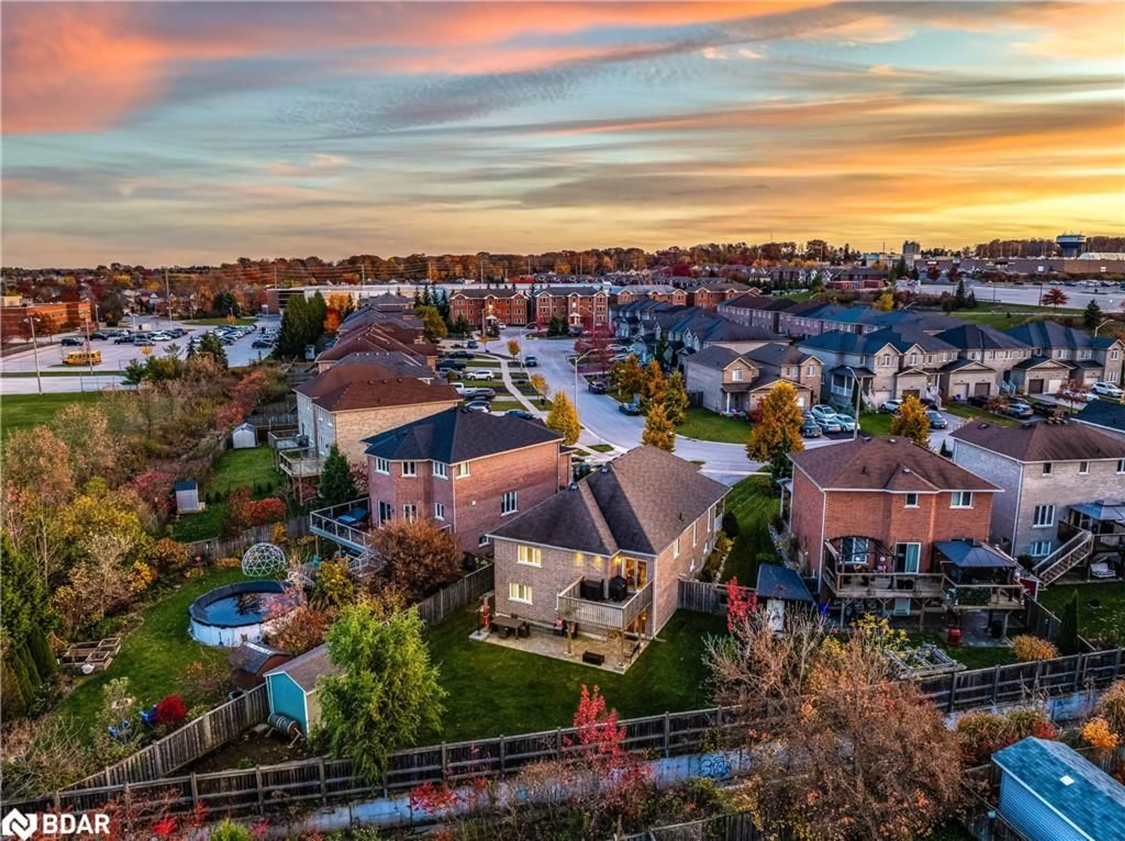 A pic from exterior of the house or condo, the fenced backyard for 14 Arch Brown Crt, Barrie Ontario L4M 0C6