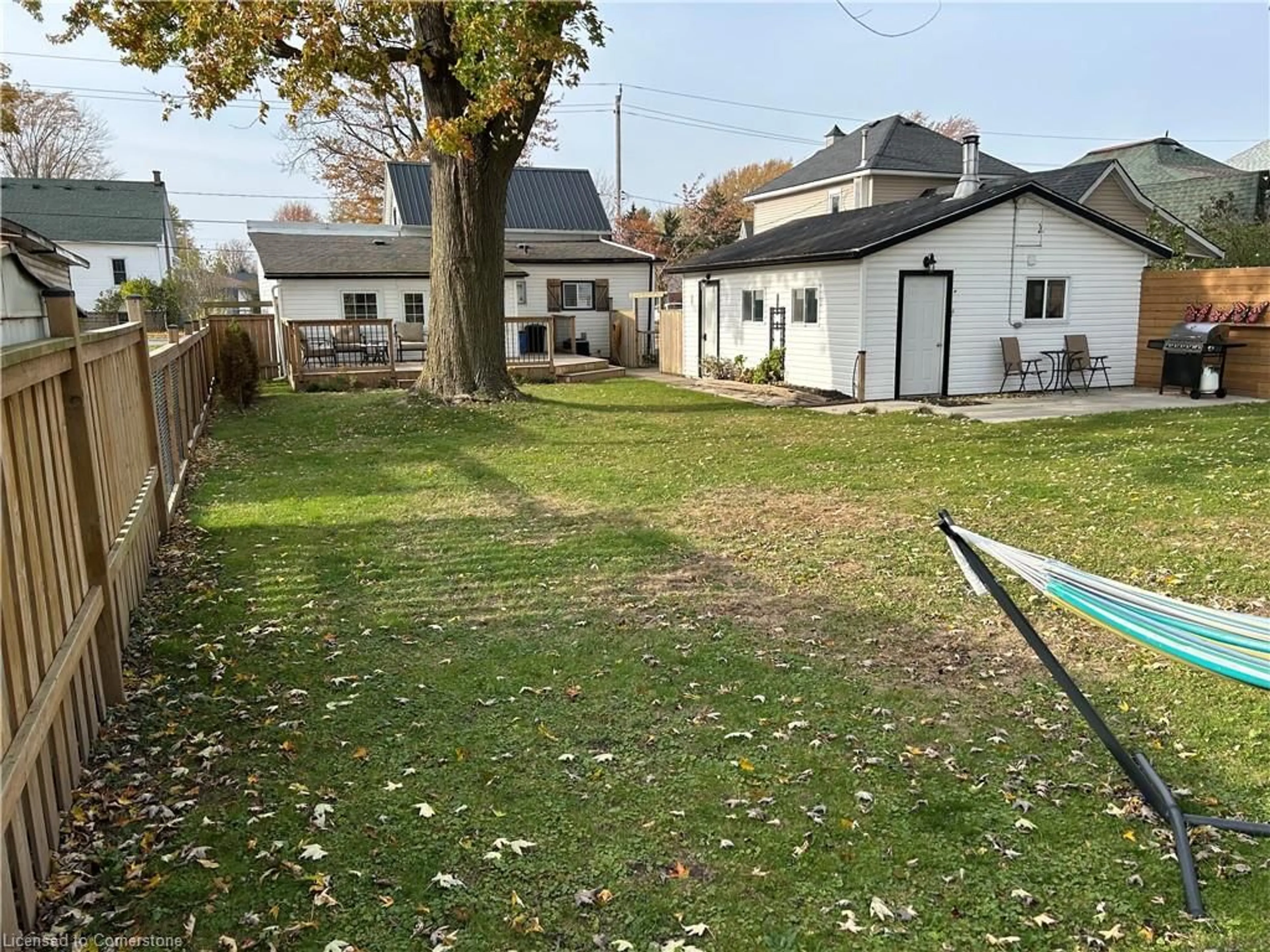 Frontside or backside of a home, the fenced backyard for 707 Tamarac St, Dunnville Ontario N1A 2E3