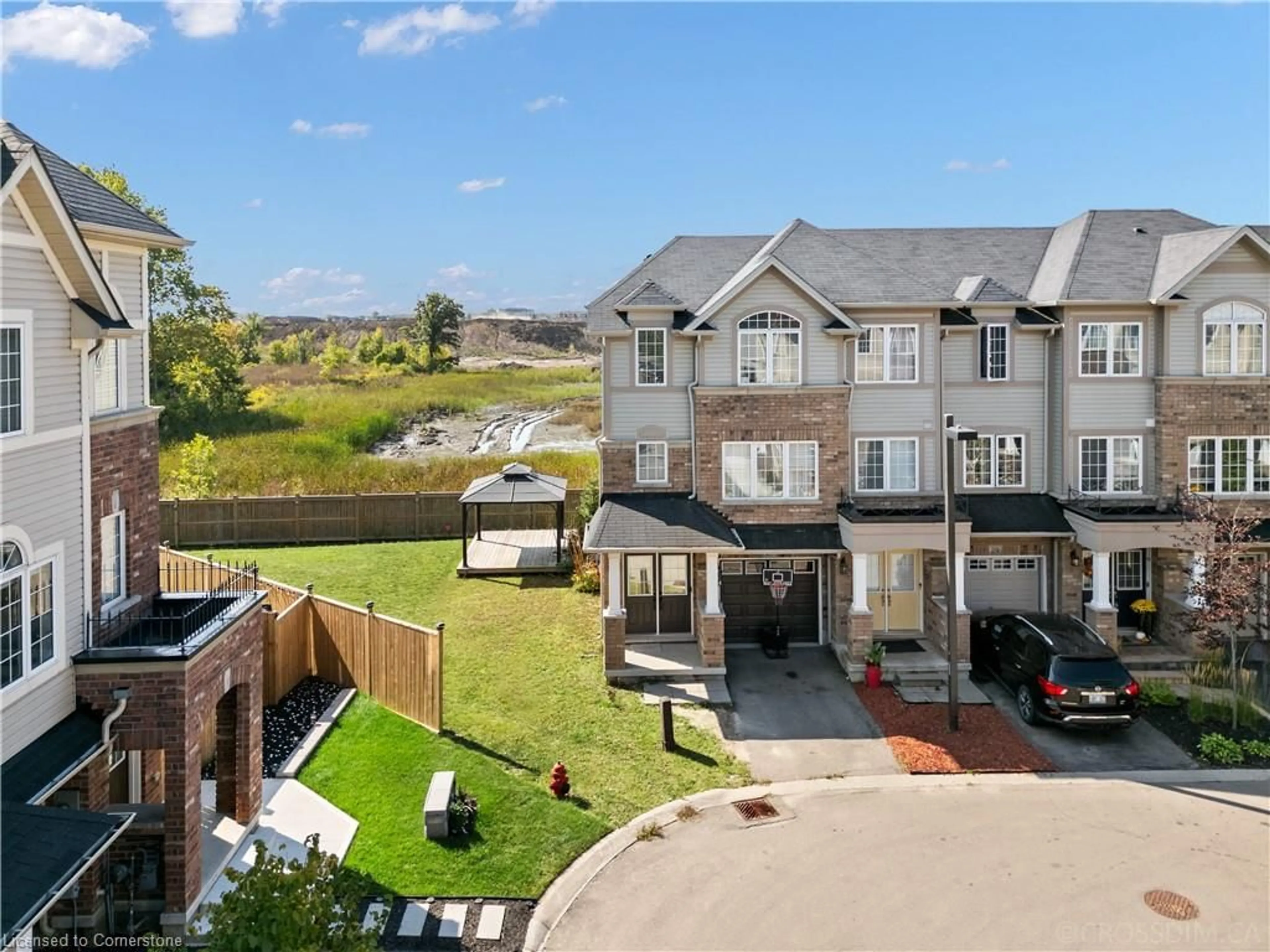 A pic from exterior of the house or condo, the fenced backyard for 27 Mayland Trail, Stoney Creek Ontario L8J 0G4