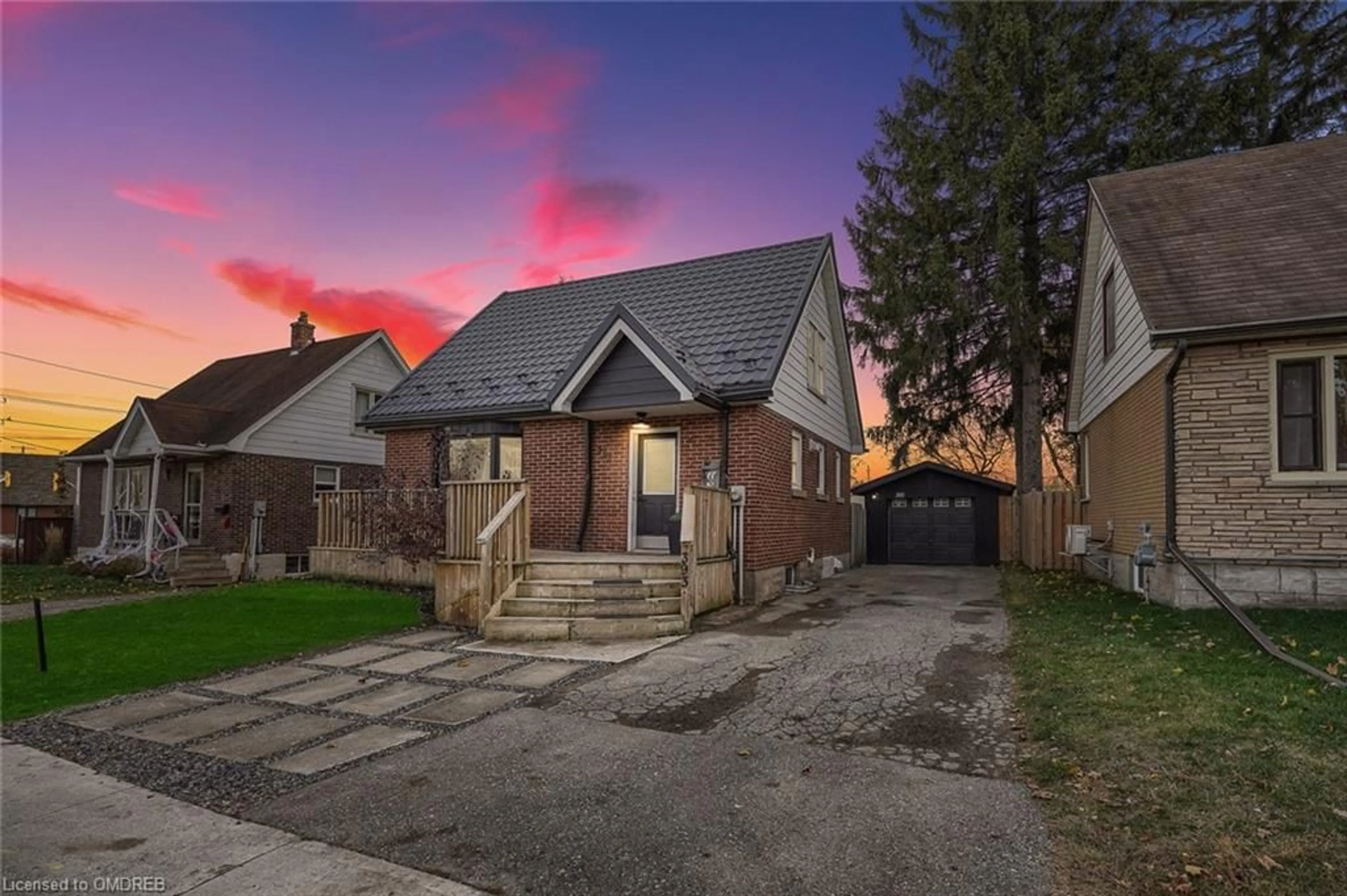 Frontside or backside of a home, the fenced backyard for 393 Weber St, Kitchener Ontario N2H 1G4