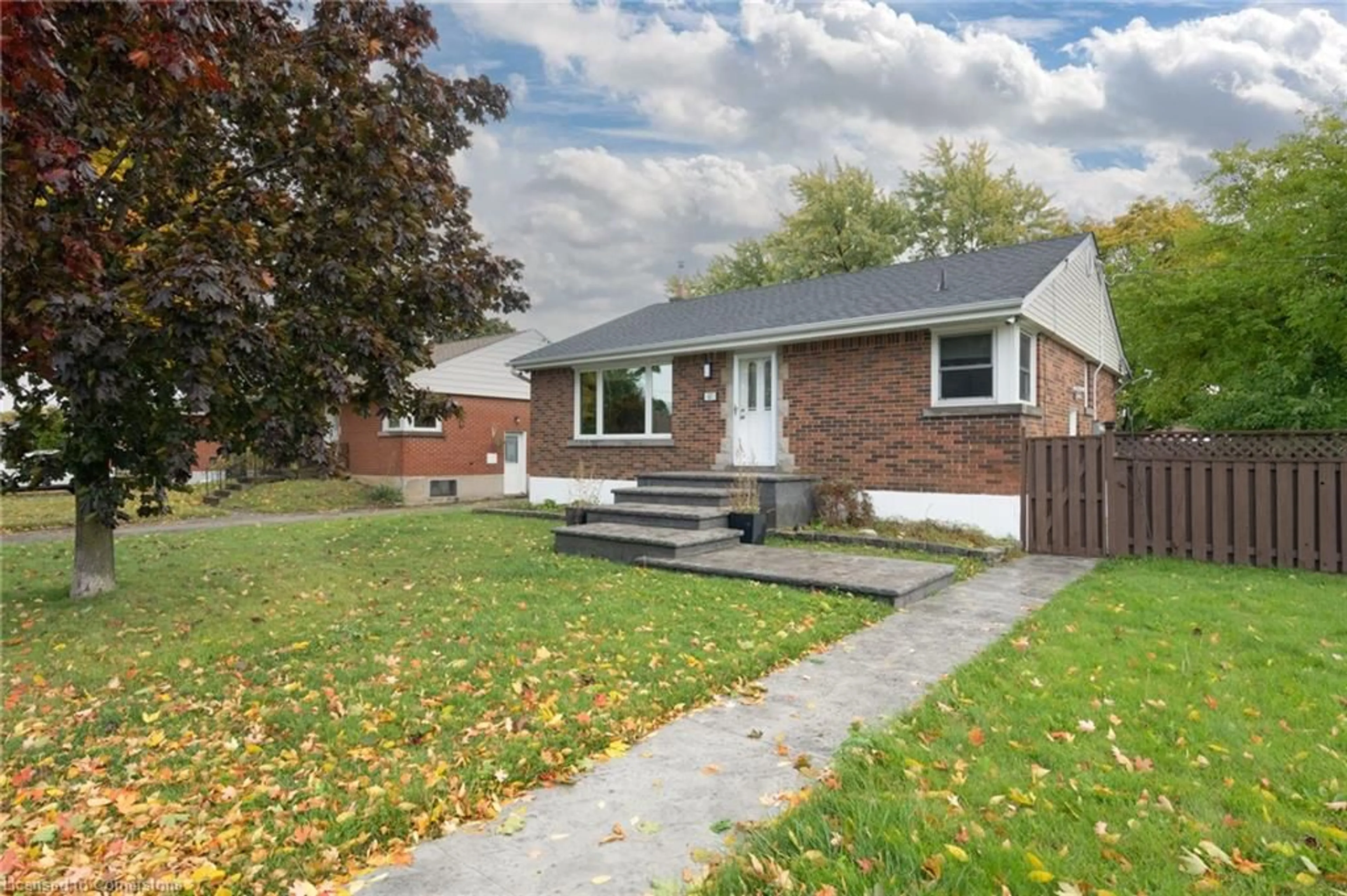 Frontside or backside of a home, the fenced backyard for 67 Greenwood St, Hamilton Ontario L8T 3N2