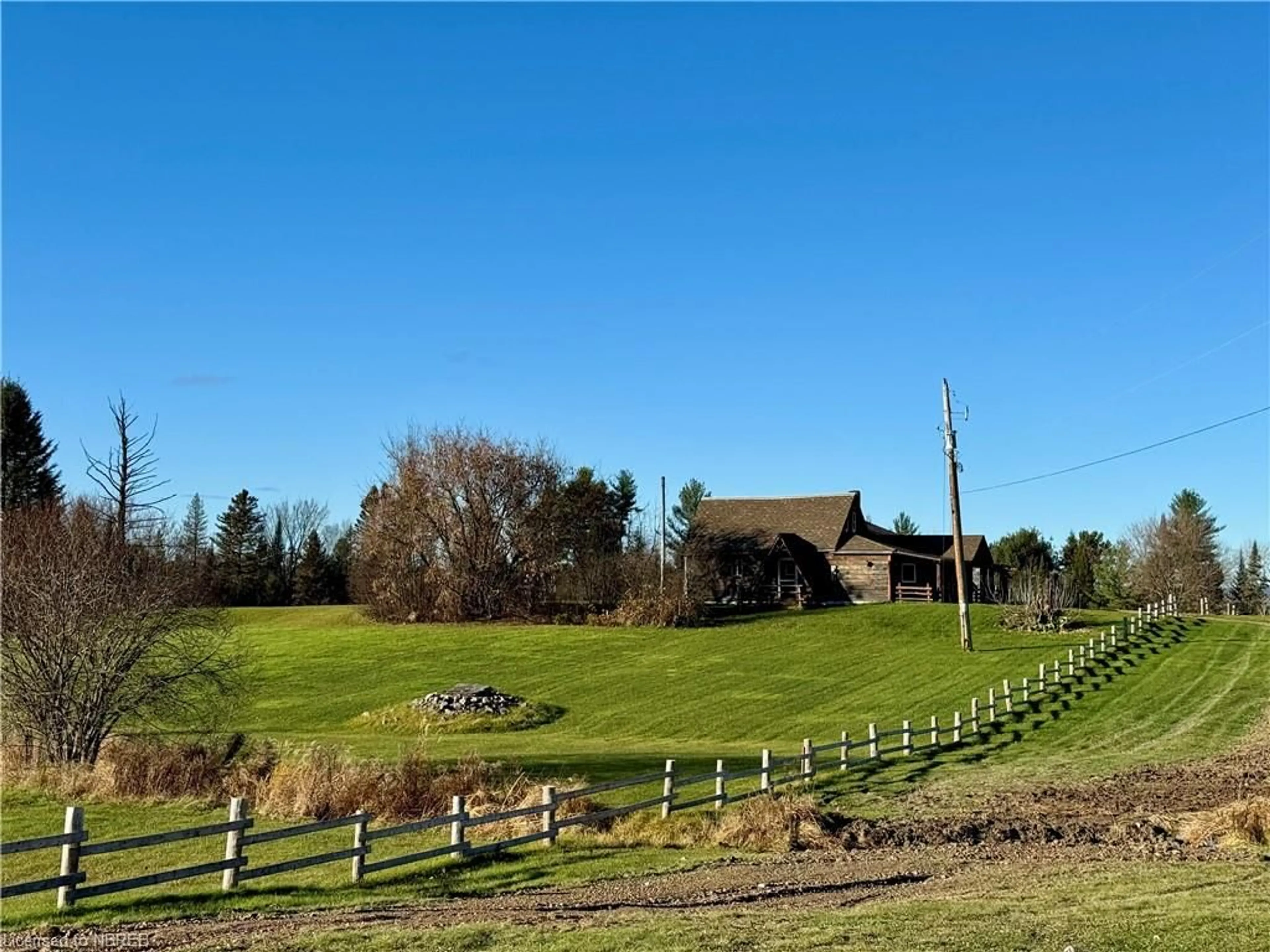 Frontside or backside of a home, the fenced backyard for 1415 Papineau Rd, Mattawa Ontario P0H 1V0