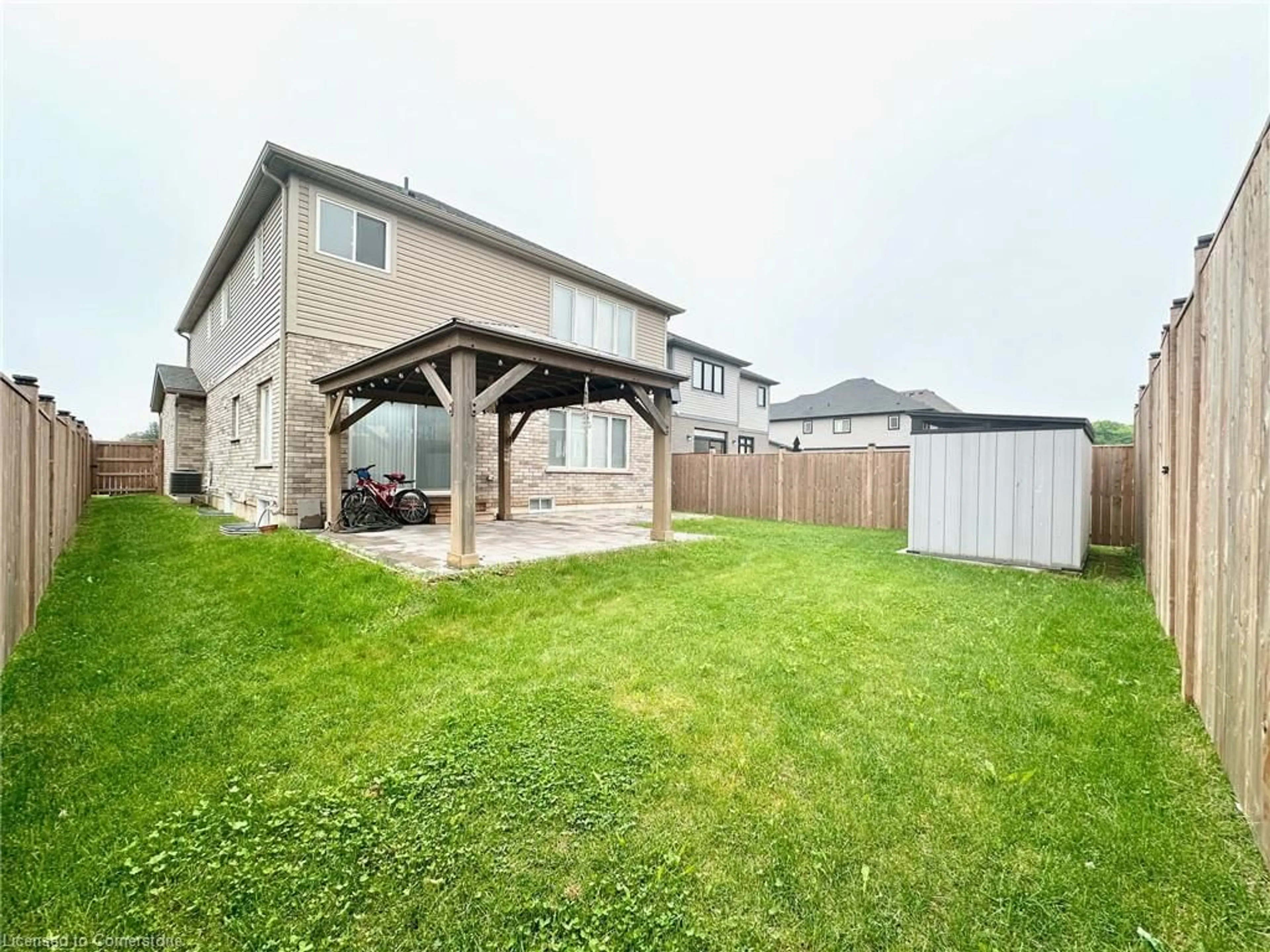 Frontside or backside of a home, the fenced backyard for 34 Swan Ave, Niagara Falls Ontario L0S 1E6