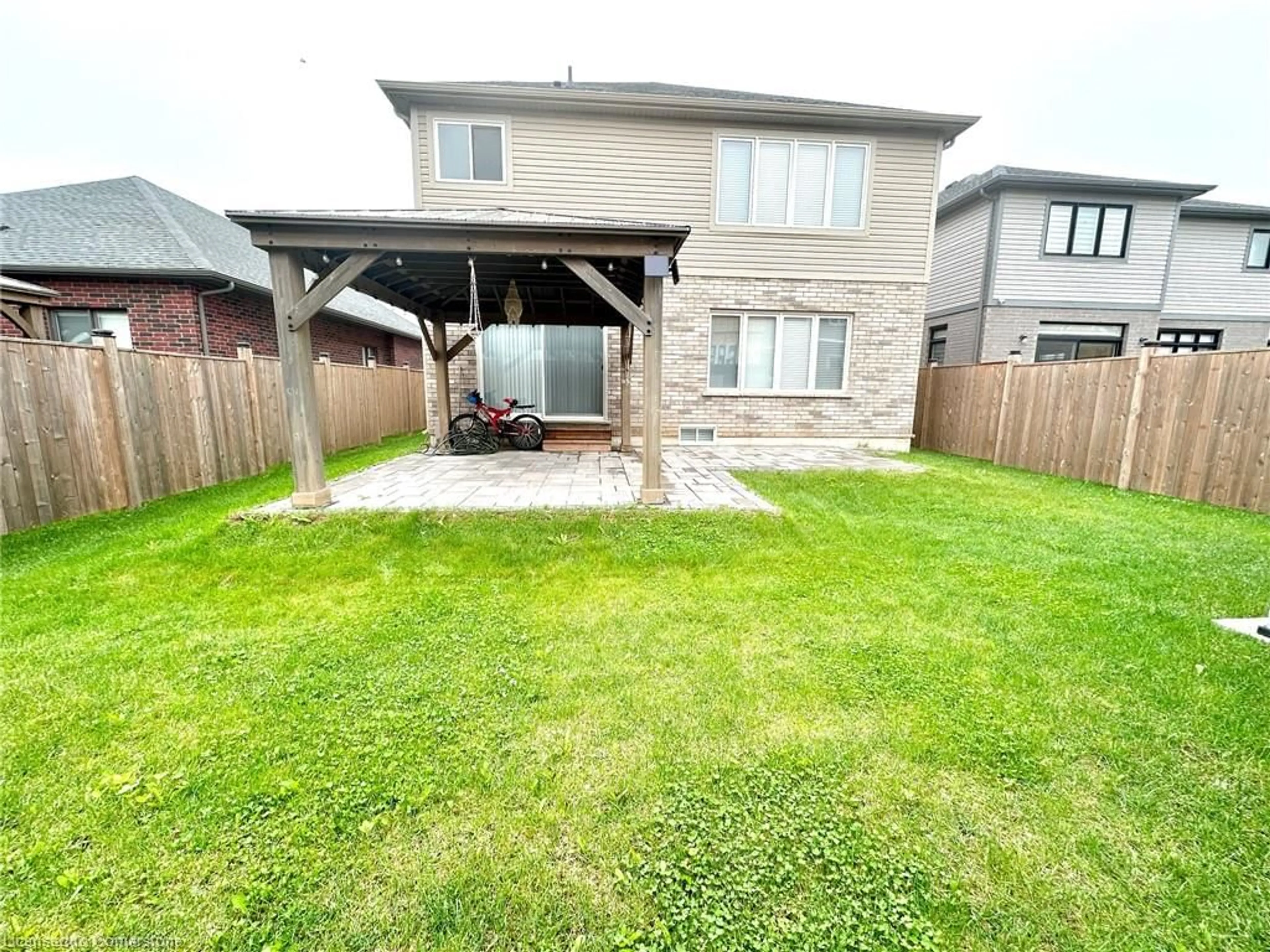 Frontside or backside of a home, the fenced backyard for 34 Swan Ave, Niagara Falls Ontario L0S 1E6