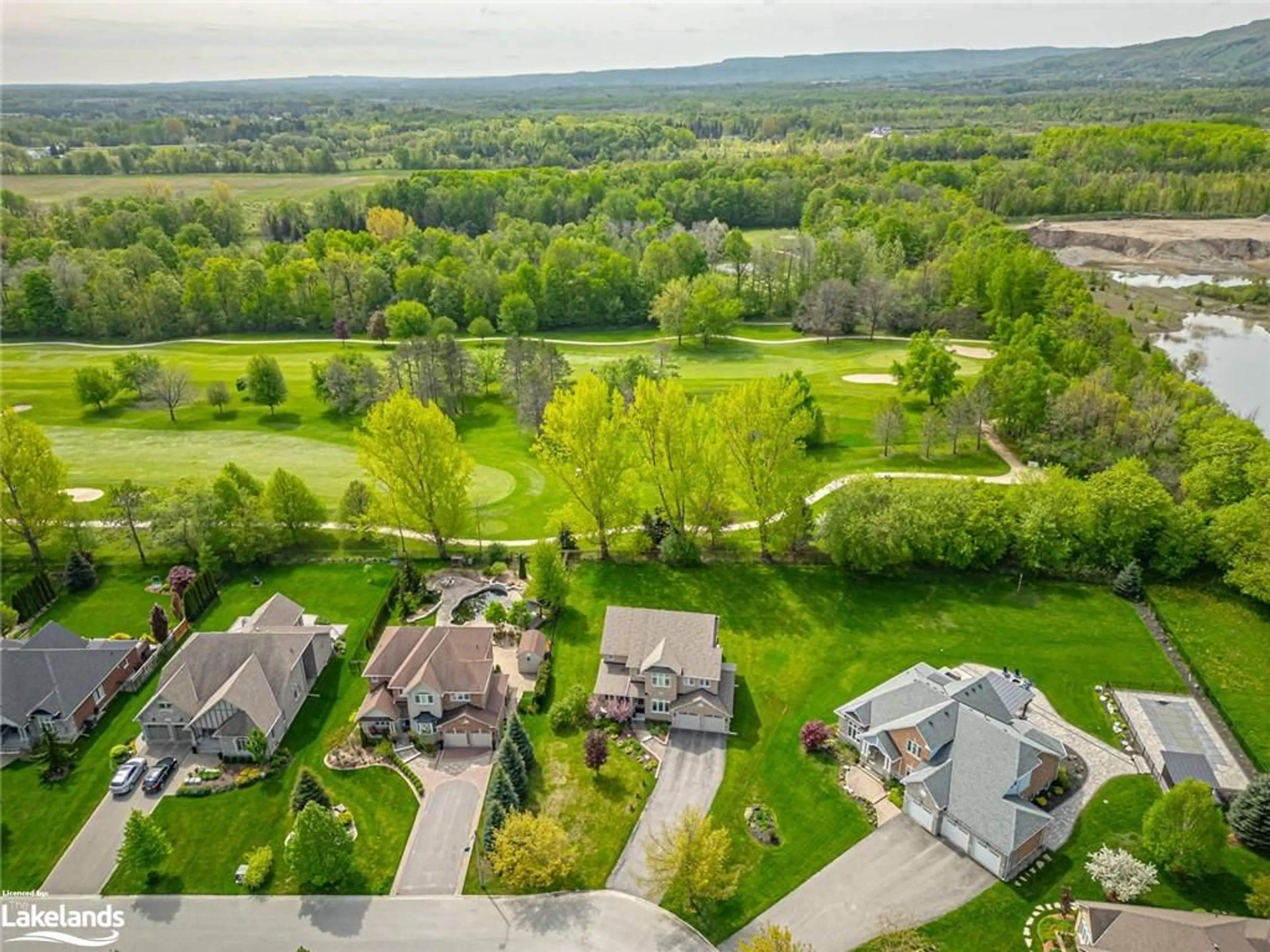 Frontside or backside of a home, the fenced backyard for 59 Kells Cres, Collingwood Ontario L9Y 0A9