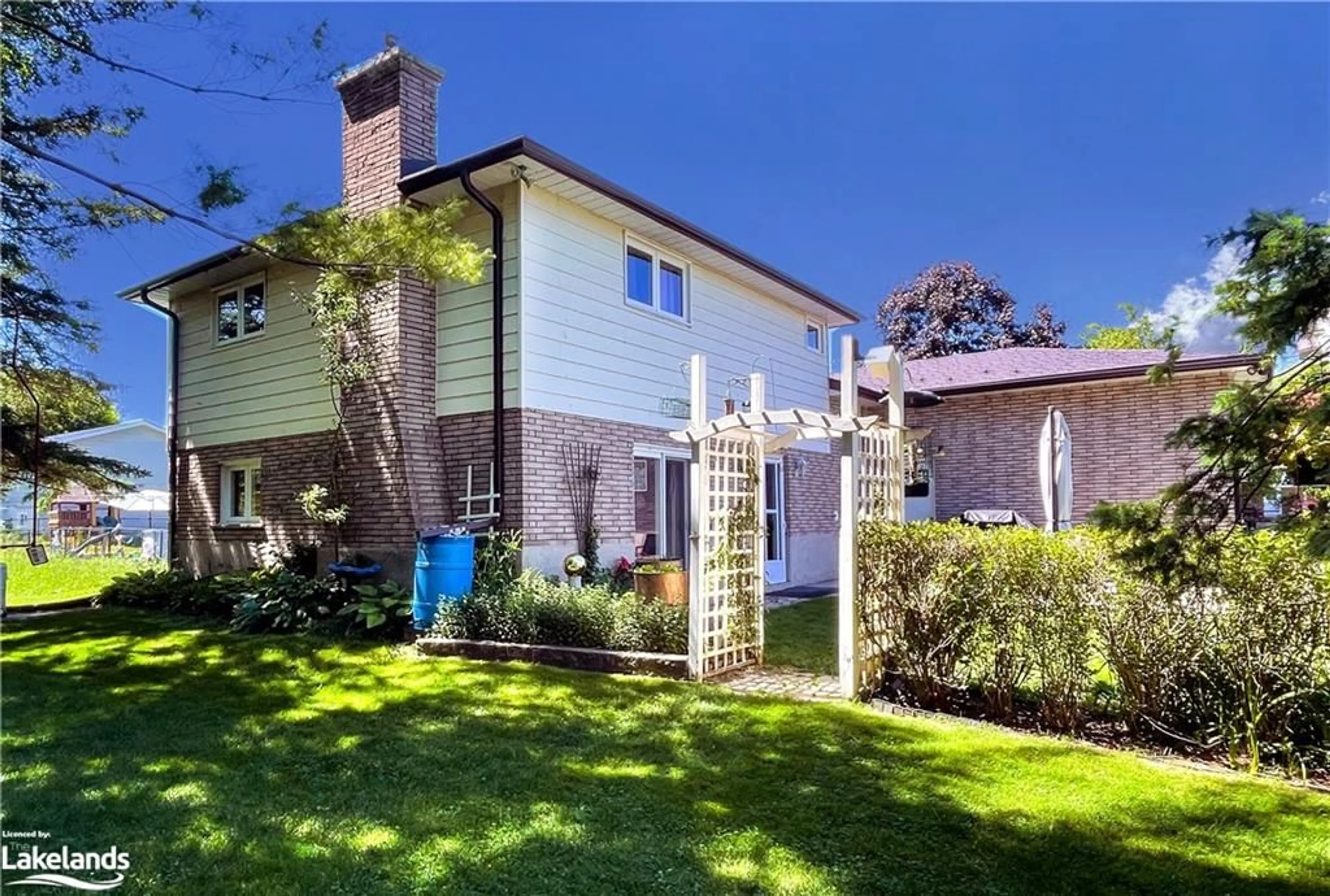 Frontside or backside of a home, the fenced backyard for 221 John Street, Stayner Ontario L0M 1S0