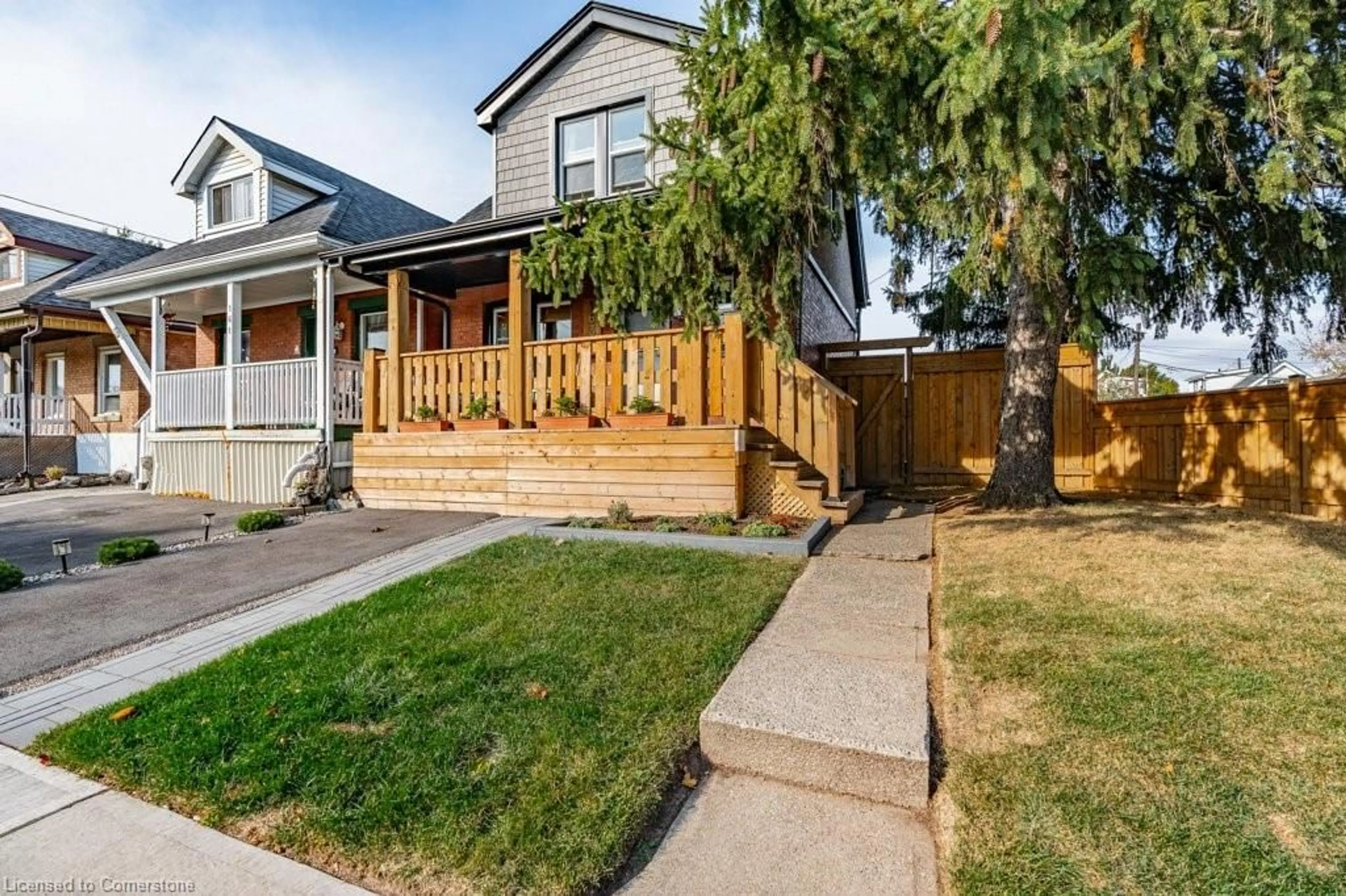 Frontside or backside of a home, the fenced backyard for 163 Cameron Ave, Hamilton Ontario L8H 4Z4