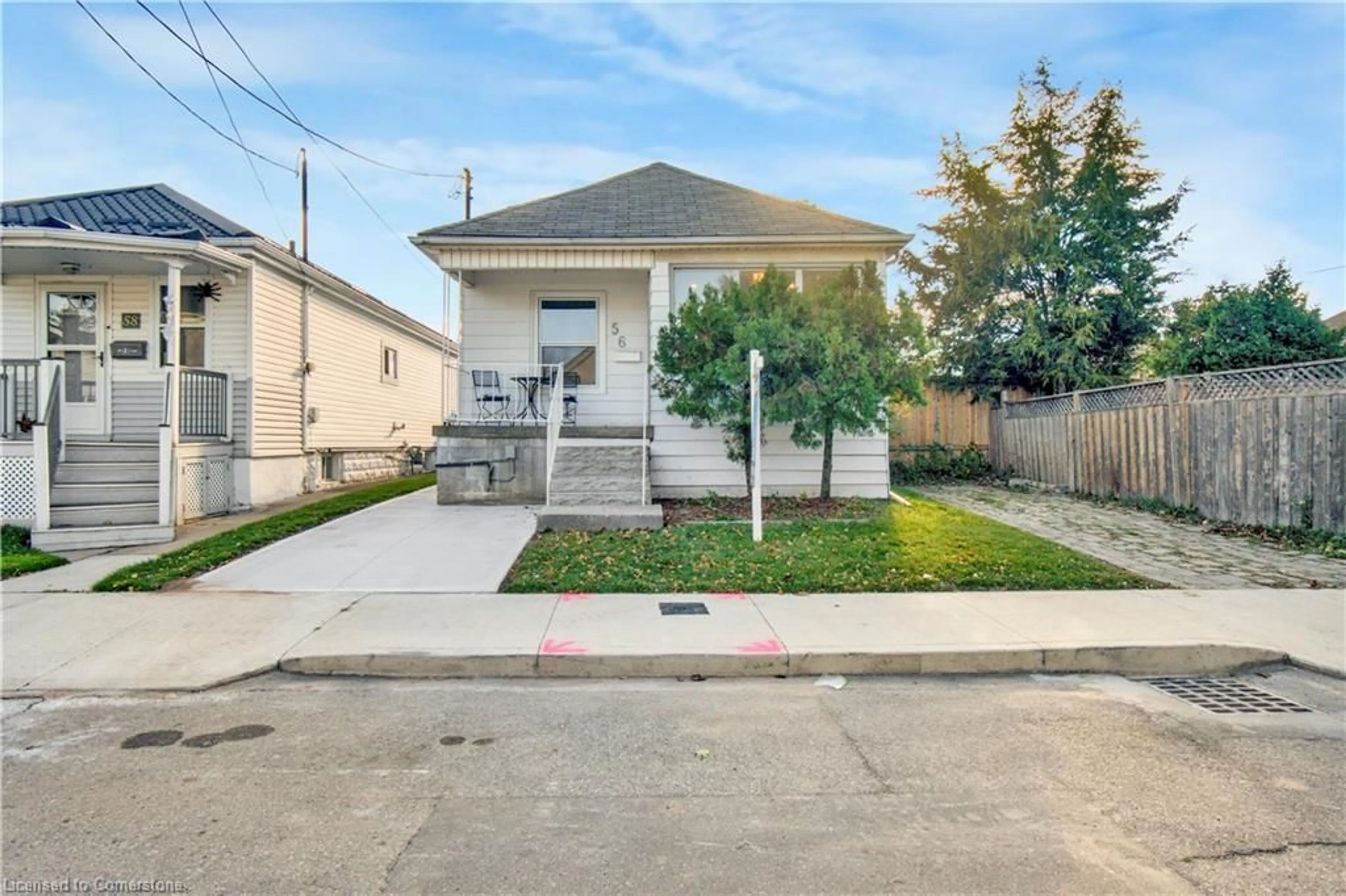 Frontside or backside of a home, the fenced backyard for 56 Cambridge Ave, Hamilton Ontario L8H 1T6