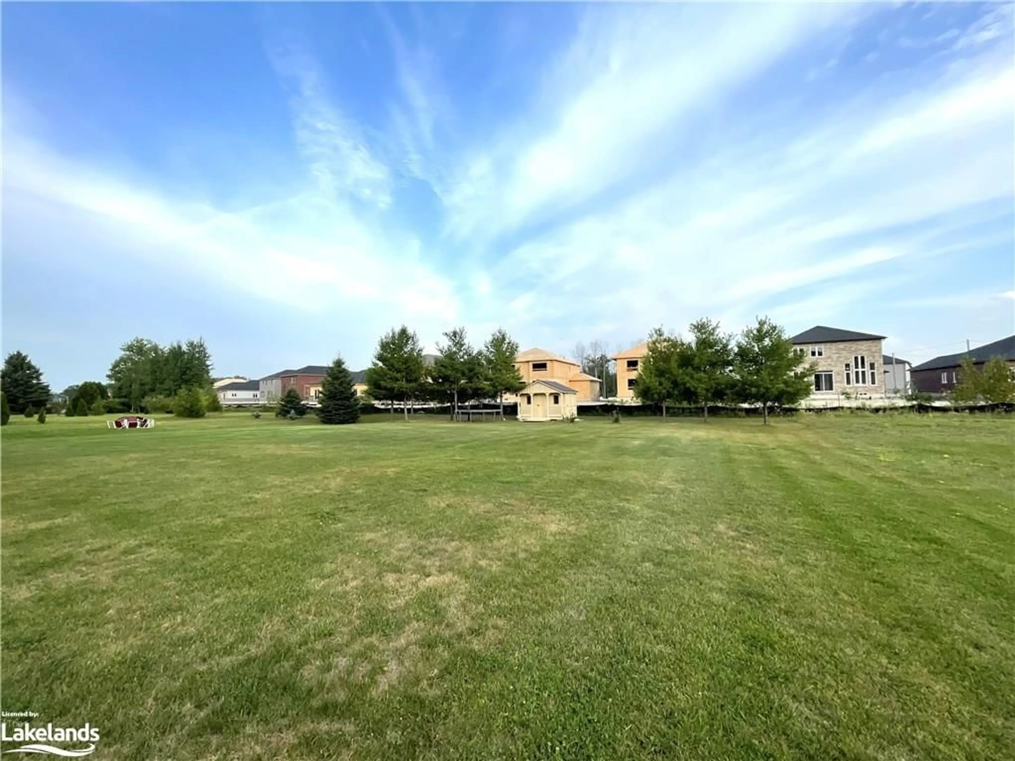 A pic from exterior of the house or condo, the fenced backyard for 16 Wasaga Sands Dr, Wasaga Beach Ontario L9Z 1J6