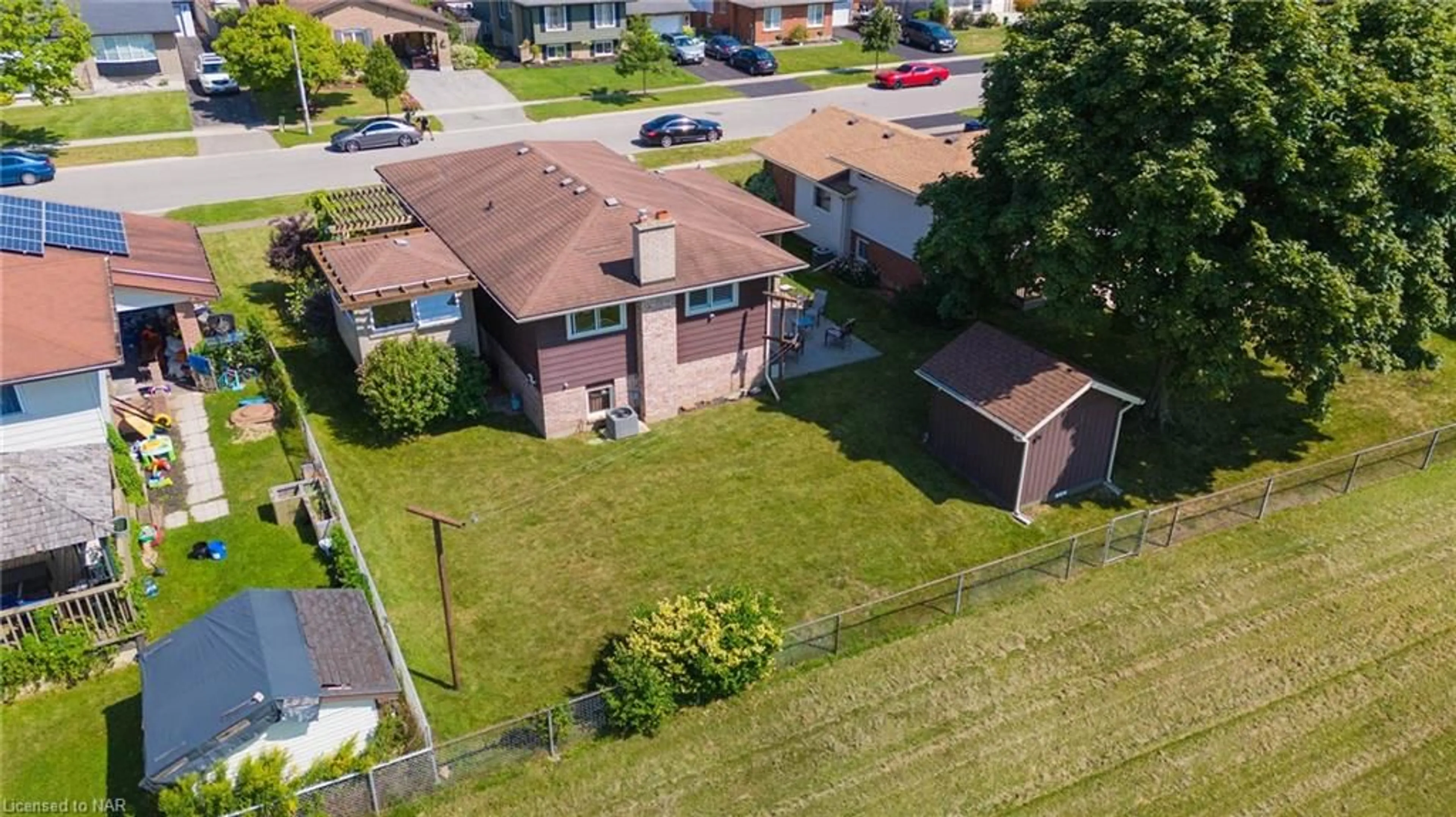 Frontside or backside of a home, the fenced backyard for 48 Robert St, Welland Ontario L3B 5T9