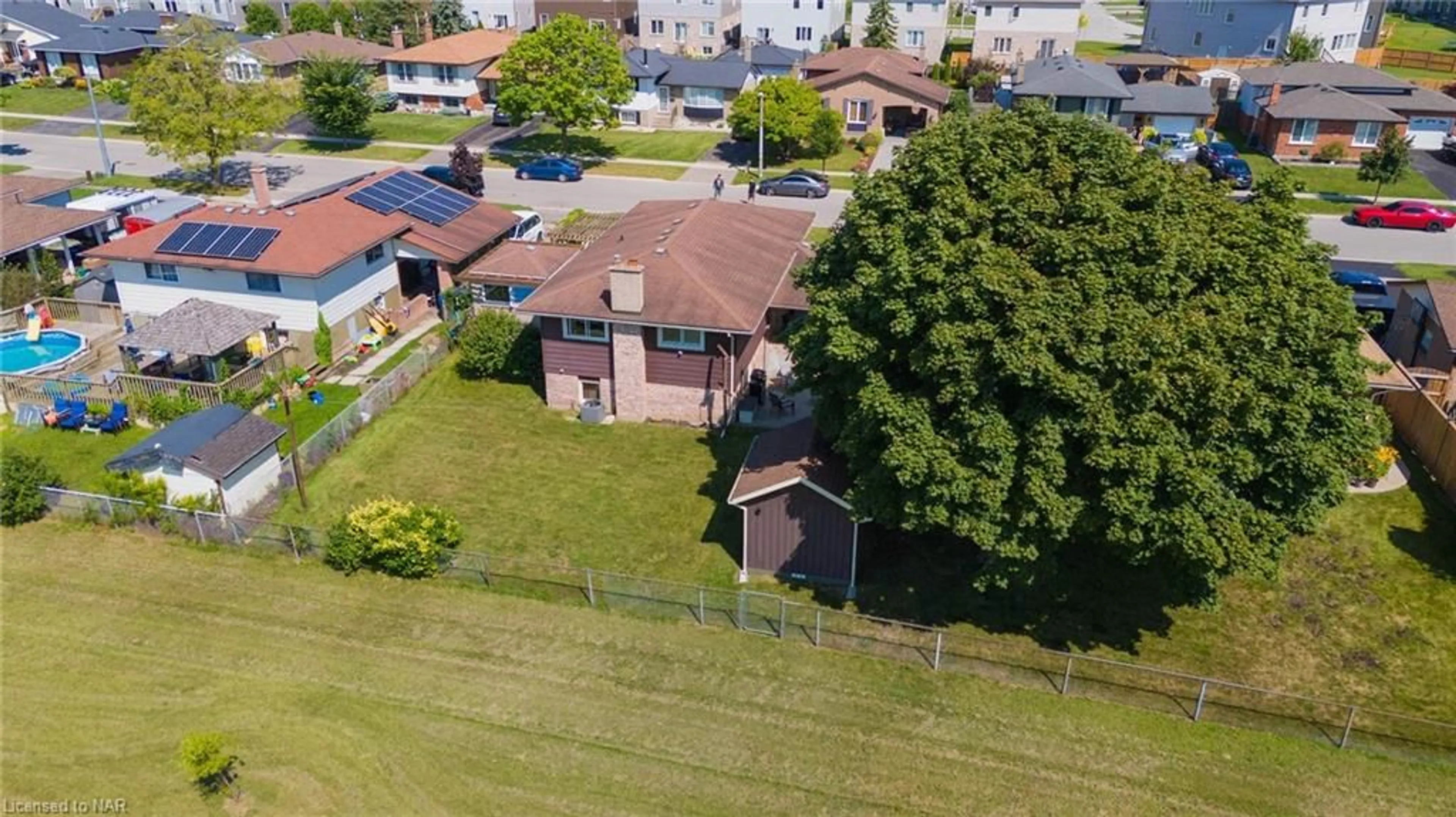 Frontside or backside of a home, the fenced backyard for 48 Robert St, Welland Ontario L3B 5T9