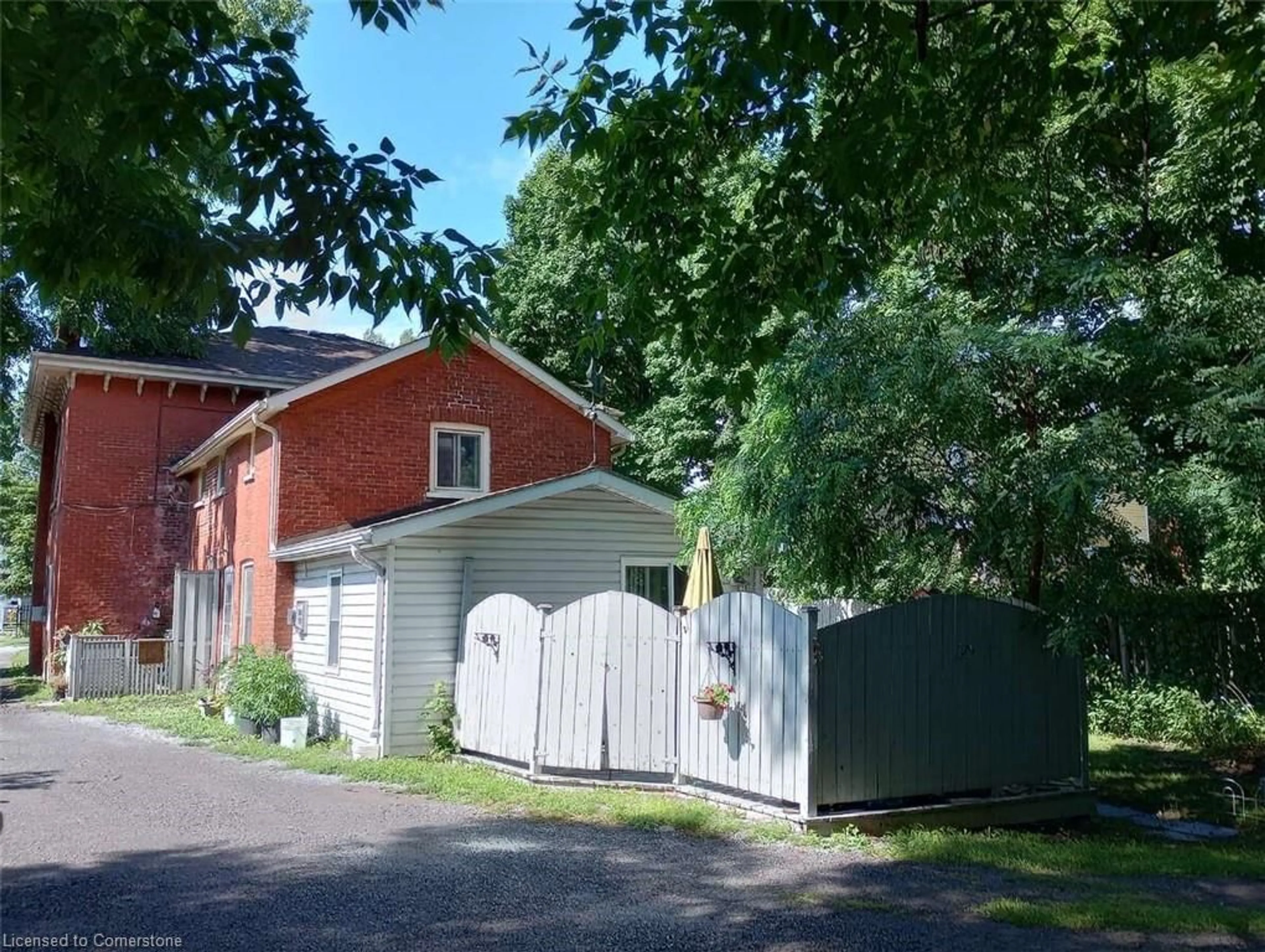 Frontside or backside of a home, the fenced backyard for 83-85 Victoria Ave, Belleville Ontario K8N 2A3