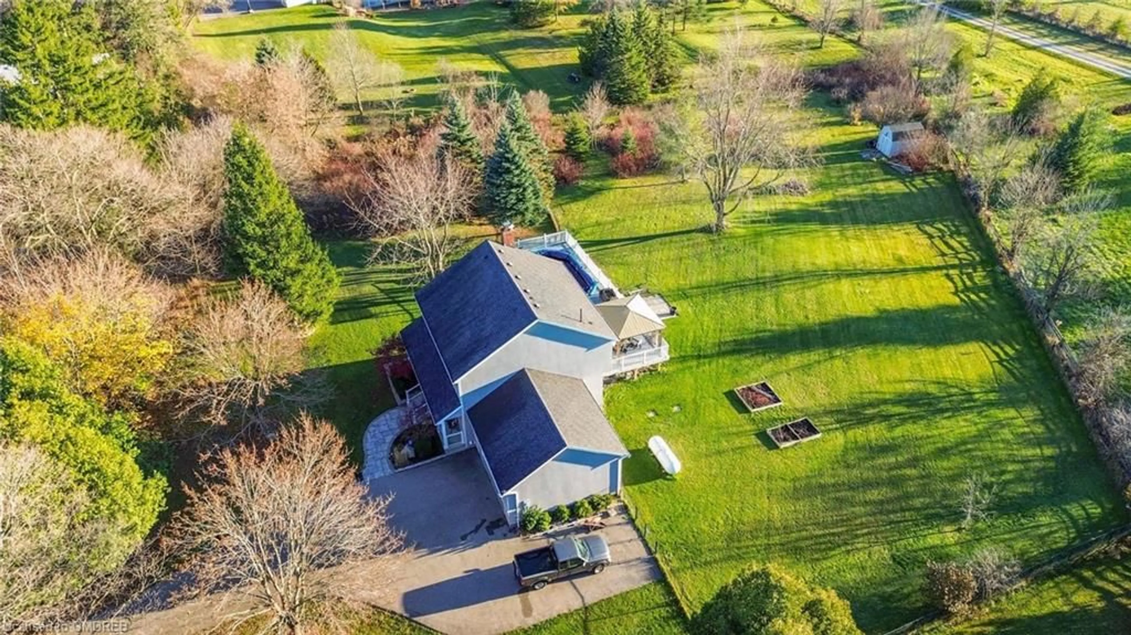 Frontside or backside of a home, the fenced backyard for 11044 1st Line, Nassagaweya Ontario L0P 1J0