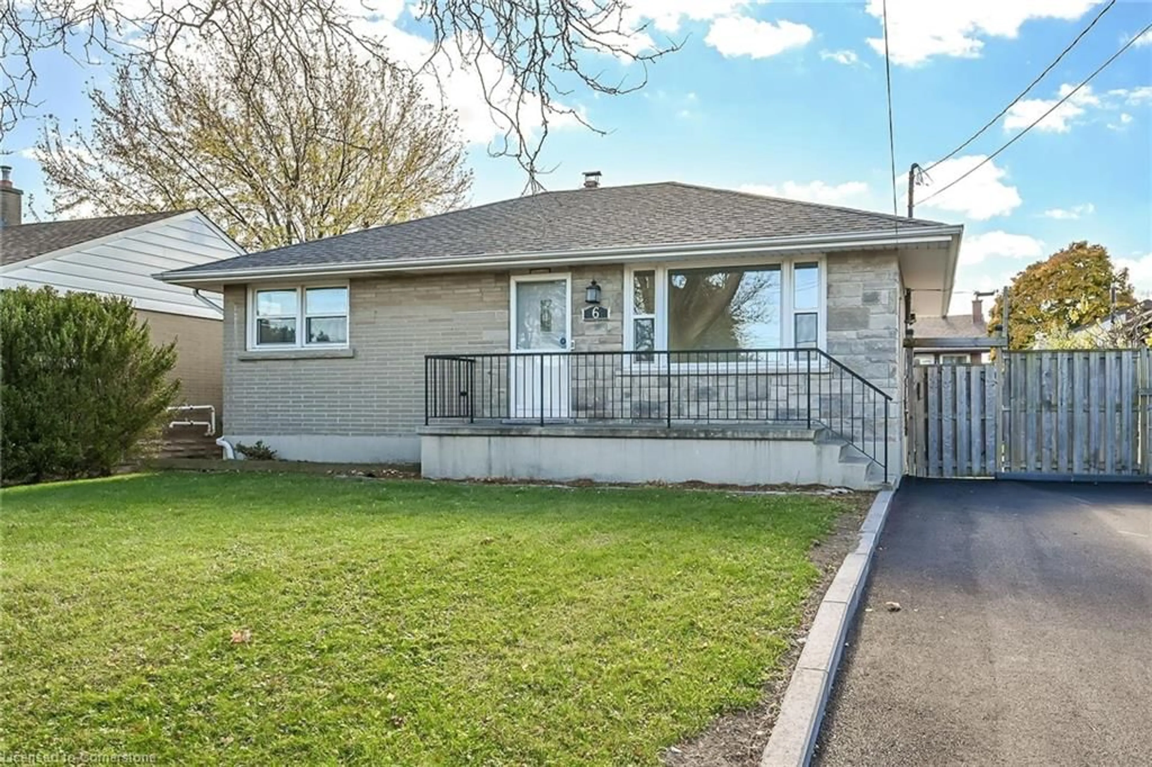 Frontside or backside of a home, the fenced backyard for 6 Grandfield St, Hamilton Ontario L8T 2H2