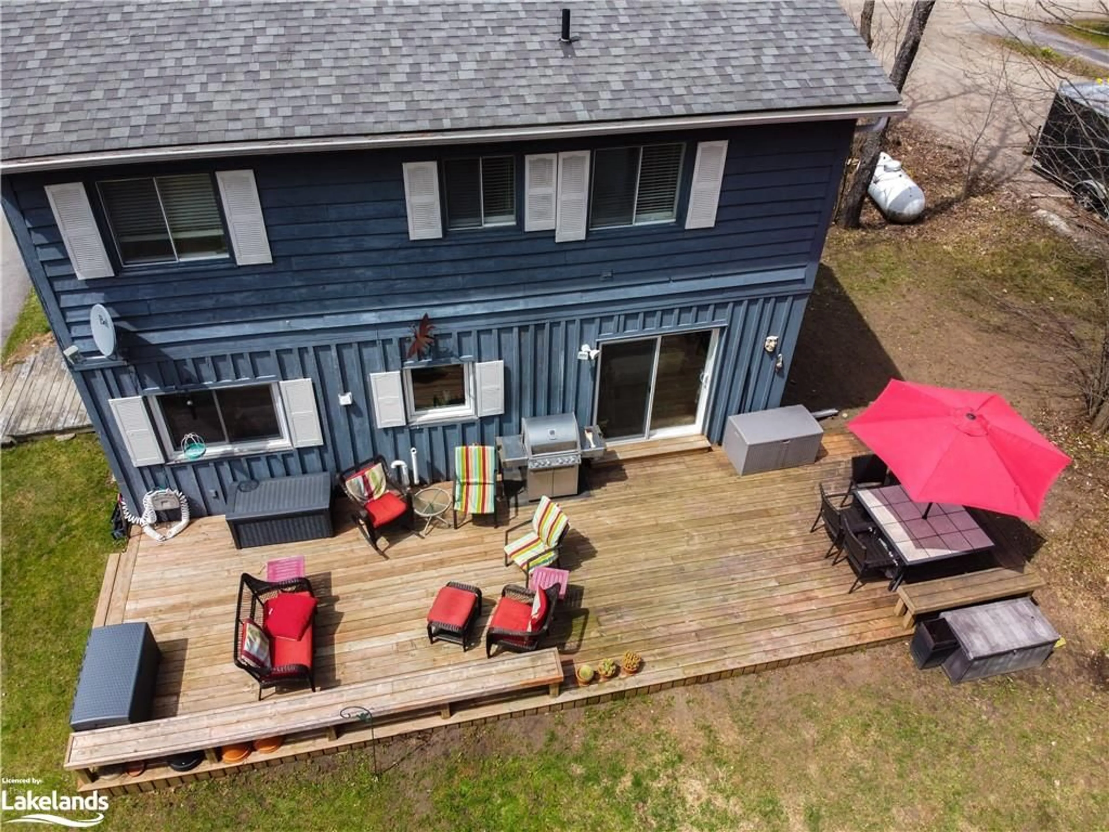 Frontside or backside of a home, the fenced backyard for 80 Invergordon Ave, Minden Ontario K0M 2K0