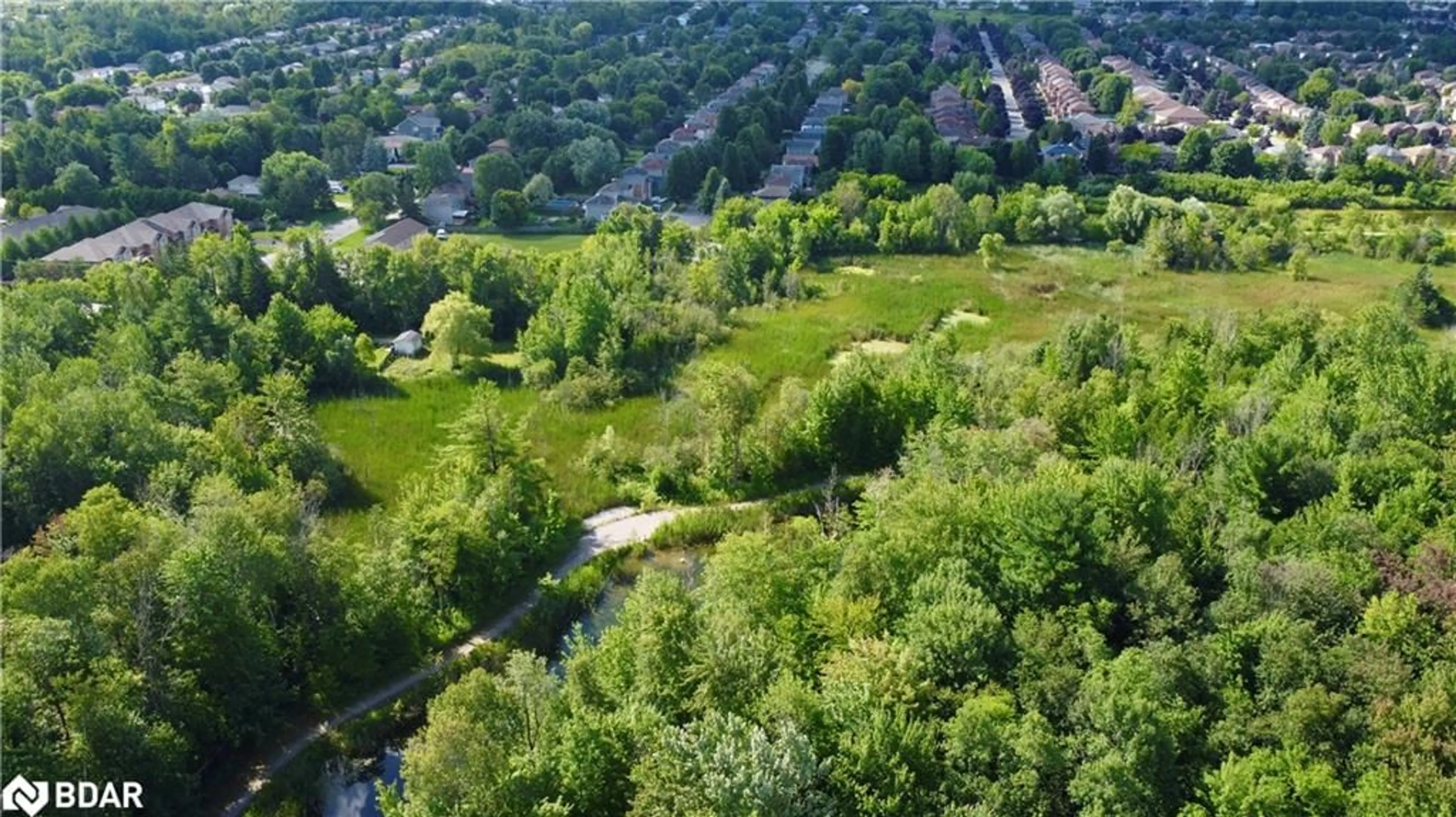 A pic from exterior of the house or condo, the fenced backyard for 51 Ferndale Dr #6, Barrie Ontario L4N 5W9