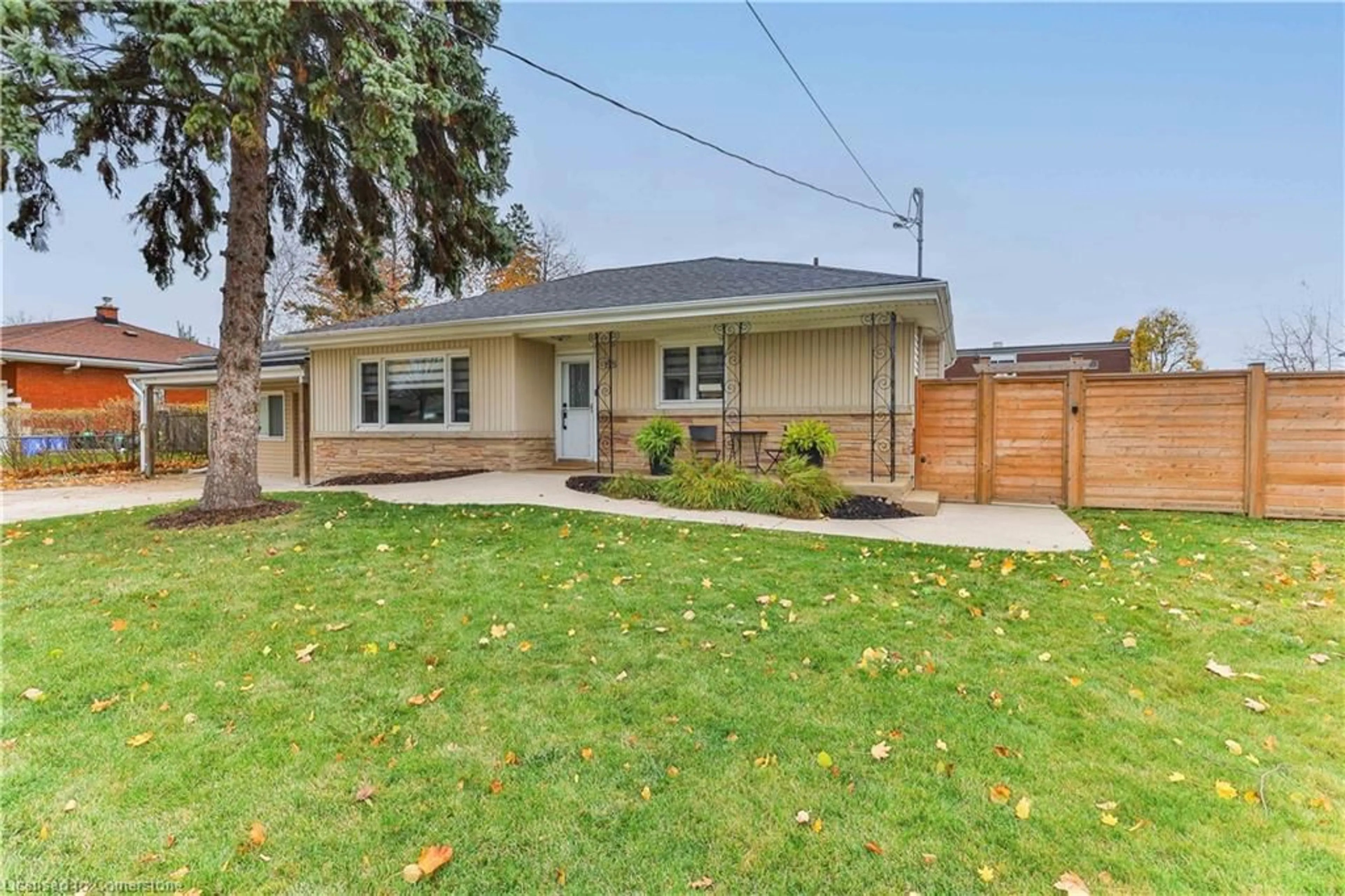 Frontside or backside of a home, the fenced backyard for 55 Deschene Ave, Hamilton Ontario L9A 3J8