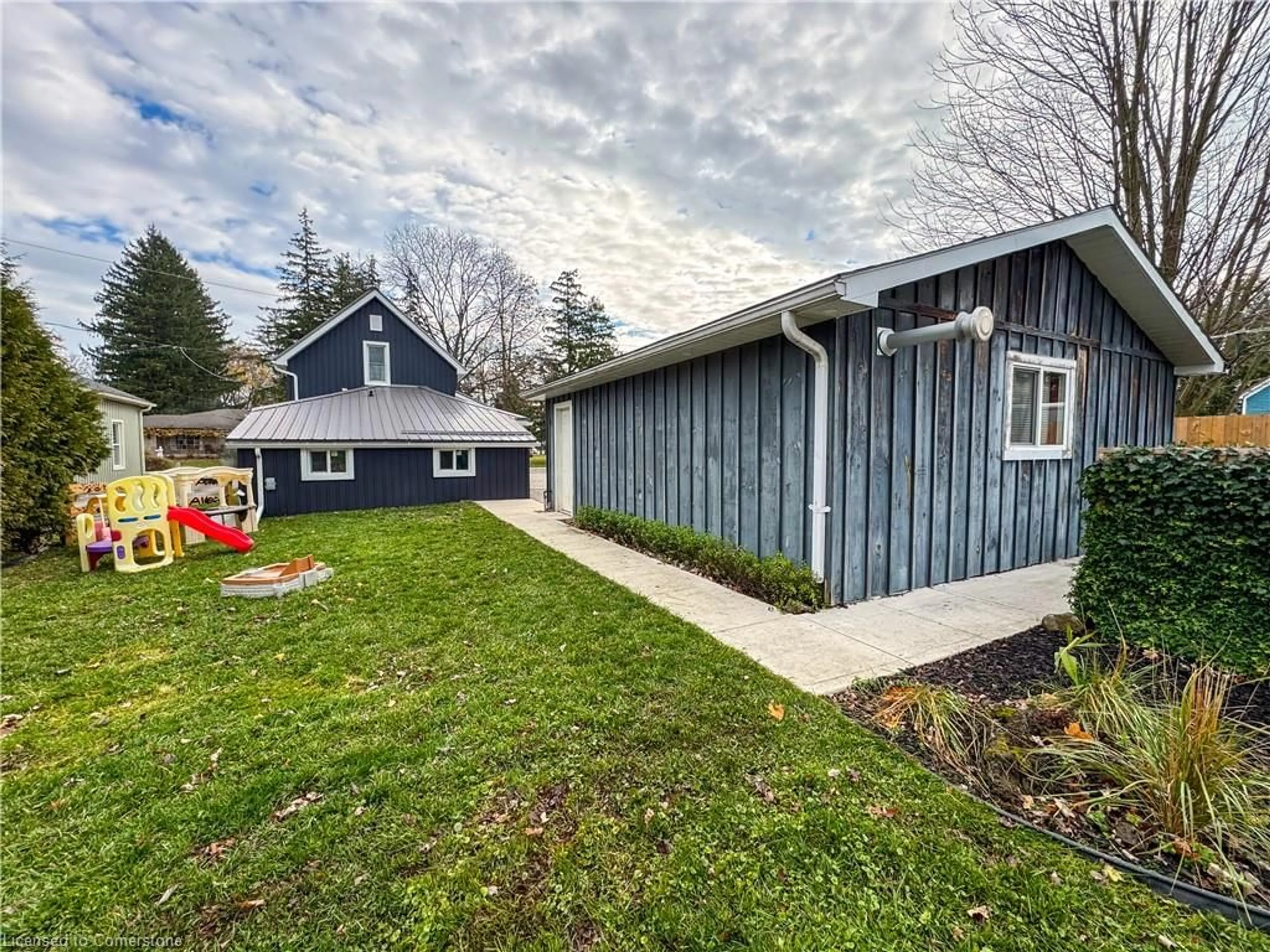 Frontside or backside of a home, the fenced backyard for 174 Wellington St, Waterford Ontario N0E 1Y0