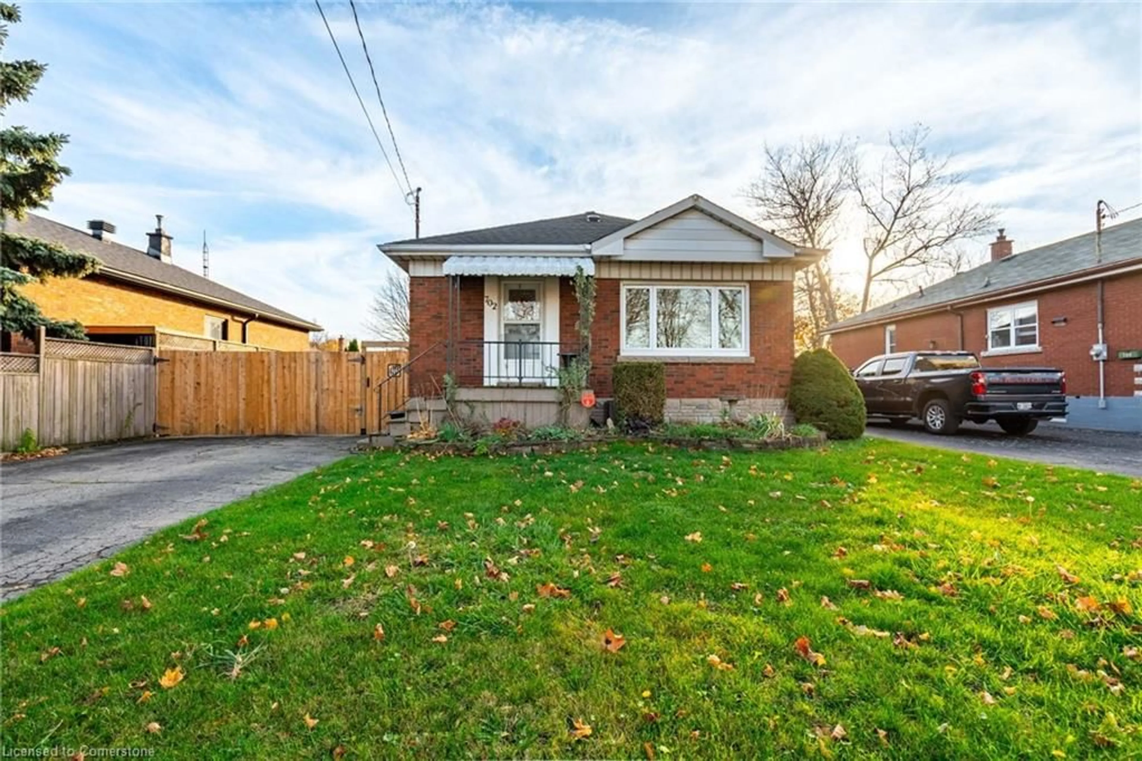 Frontside or backside of a home, the fenced backyard for 702 Seventh Ave, Hamilton Ontario L8T 1V1