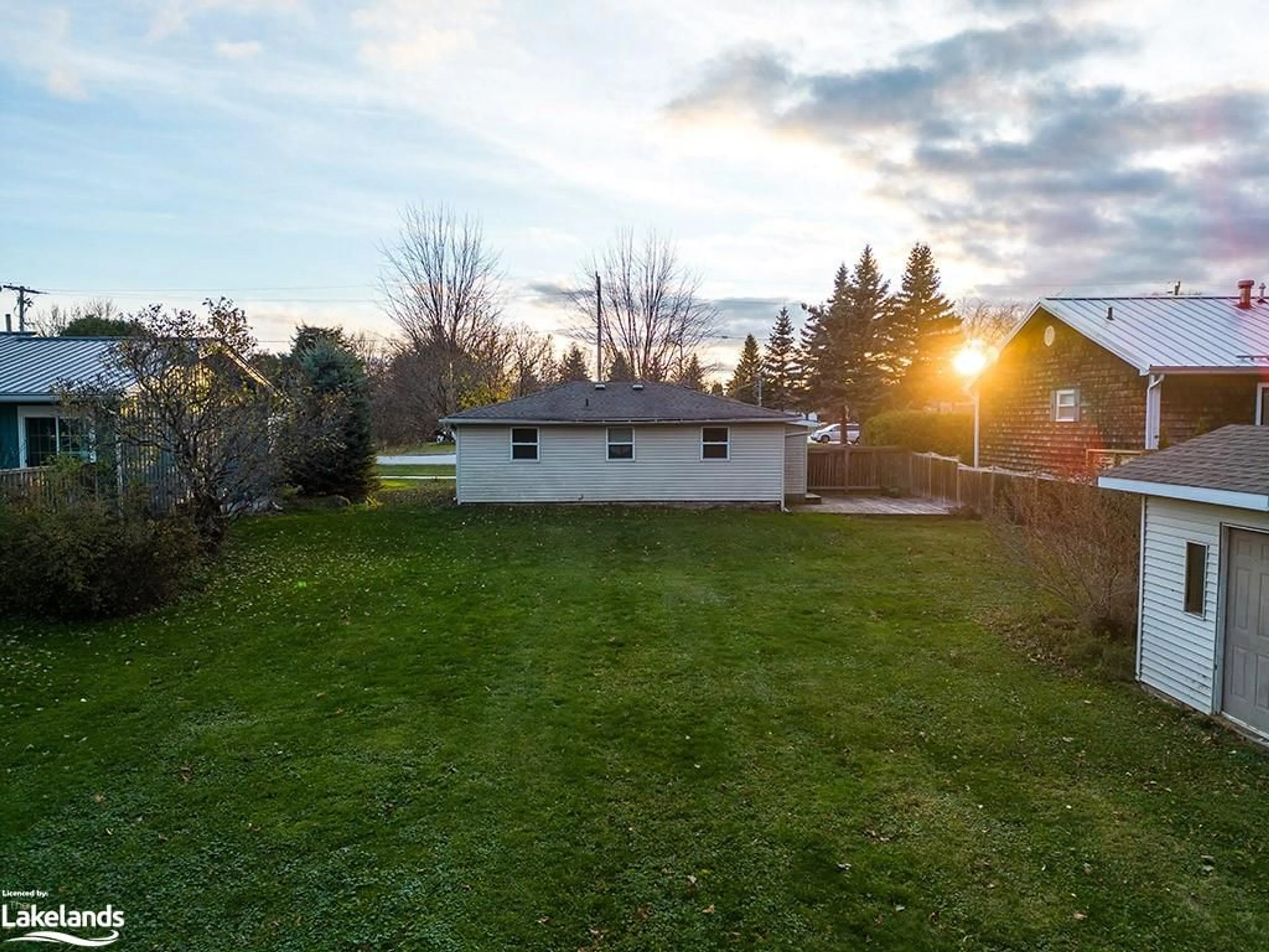 Frontside or backside of a home, the fenced backyard for 14 Napier St, Thornbury Ontario N0H 2P0