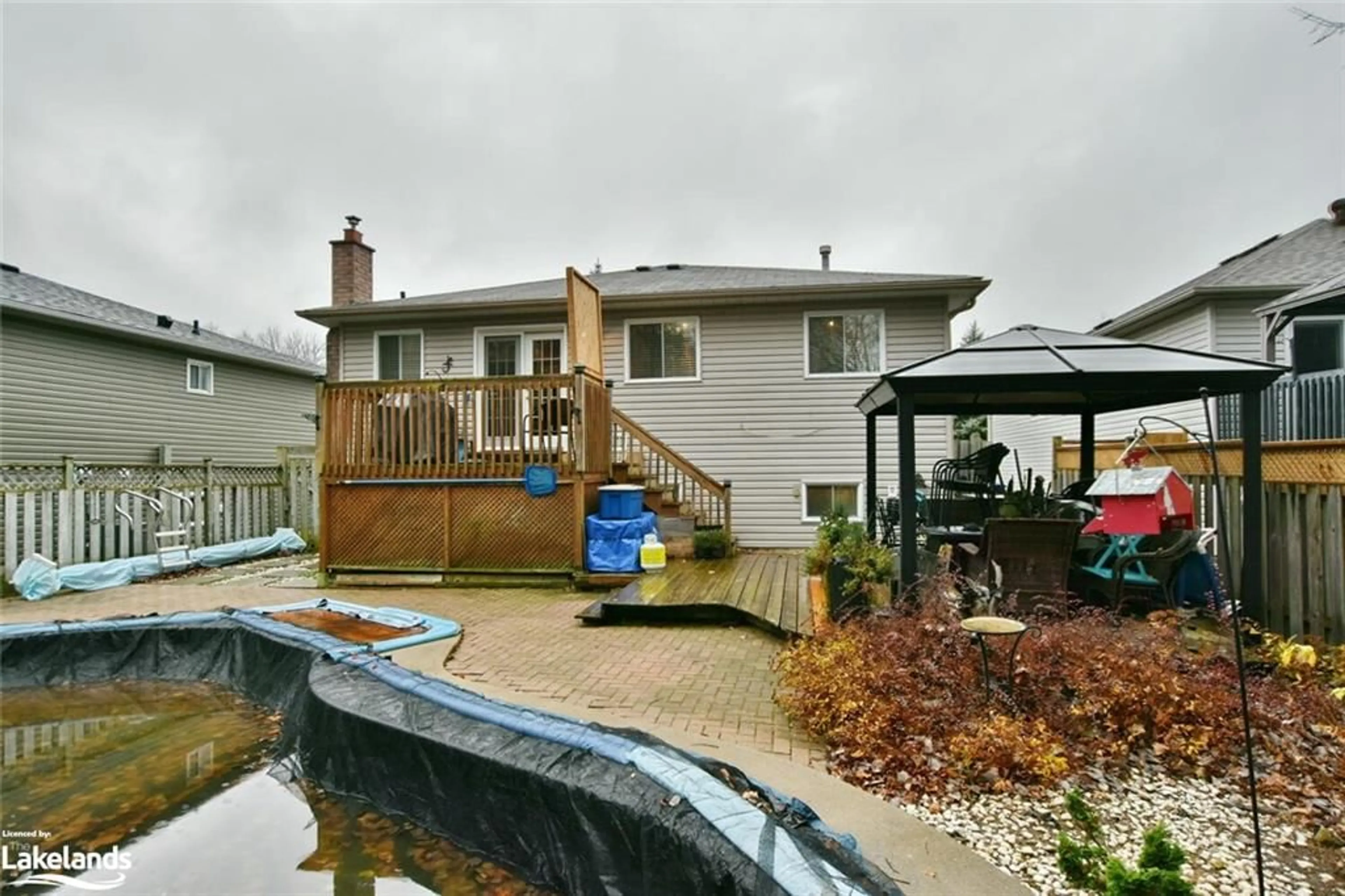 Frontside or backside of a home, the fenced backyard for 97 Glen Eton Rd, Wasaga Beach Ontario L9Z 1E8