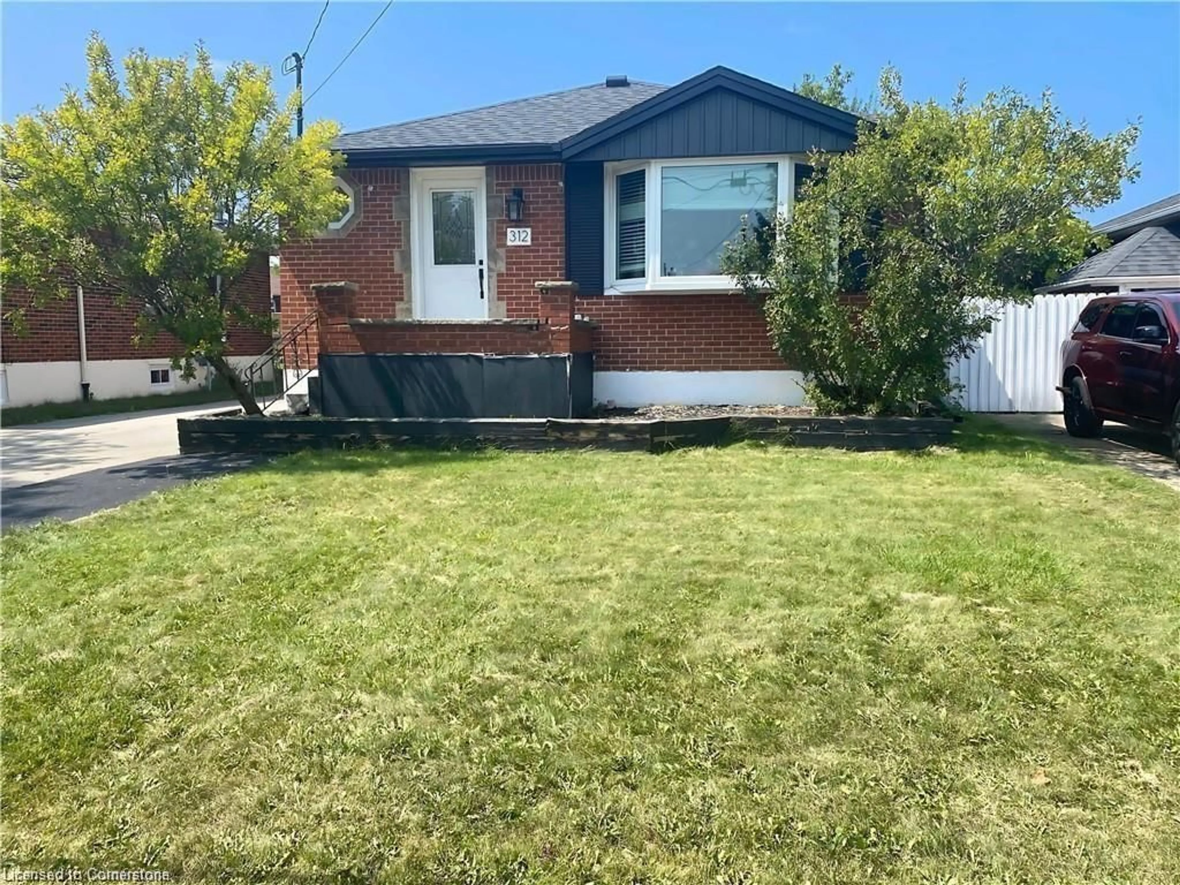 Frontside or backside of a home, the fenced backyard for 312 East 45th St, Hamilton Ontario L8T 3K8