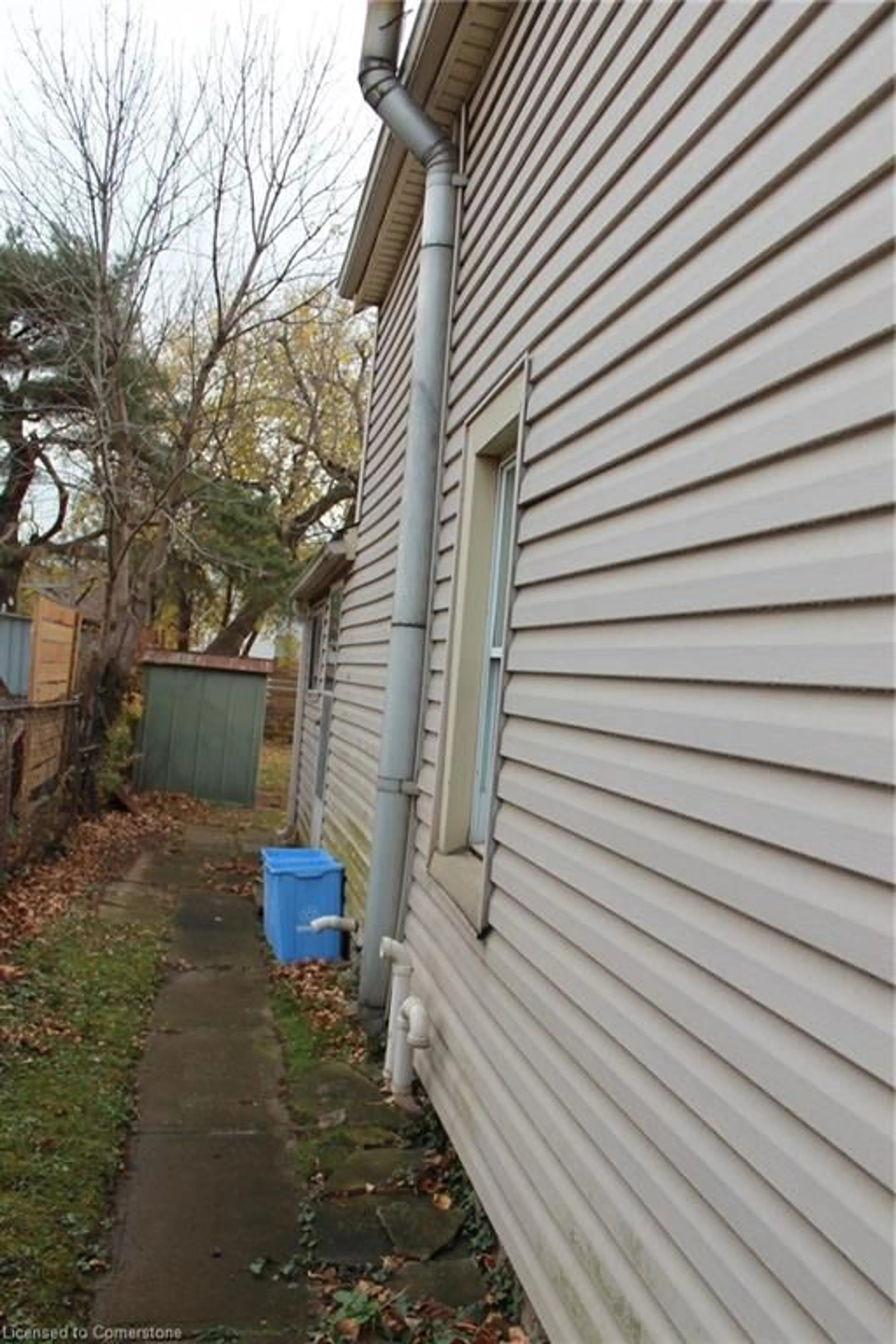 Frontside or backside of a home, the fenced backyard for 24 Carlisle St, Hamilton Ontario L8H 4C3