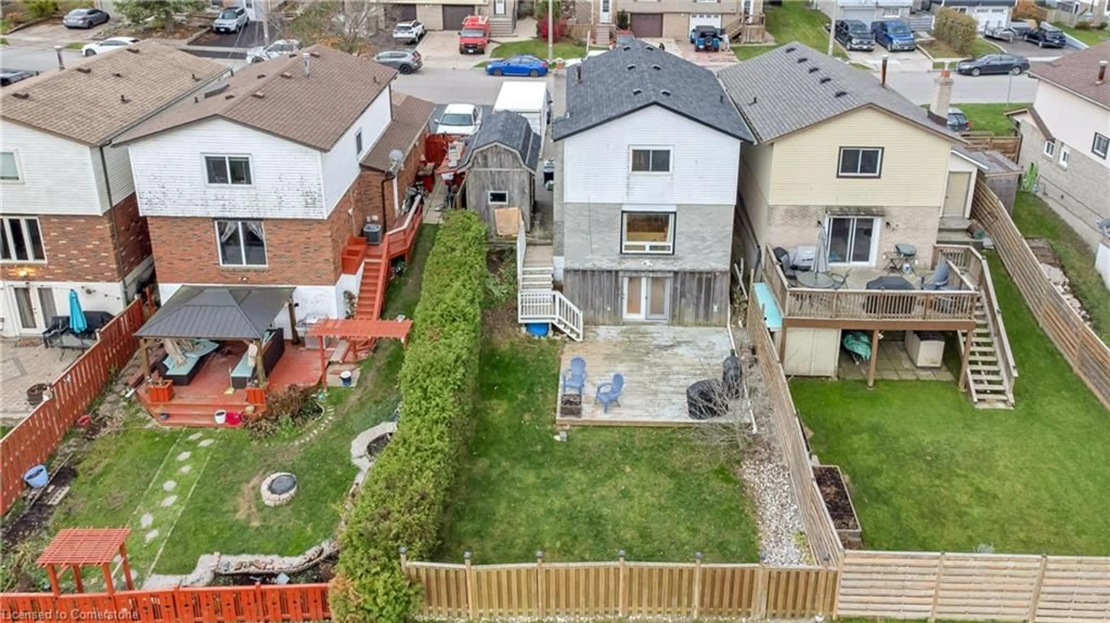 Frontside or backside of a home, the fenced backyard for 37 Burke Dr, Caledonia Ontario N3W 1C3