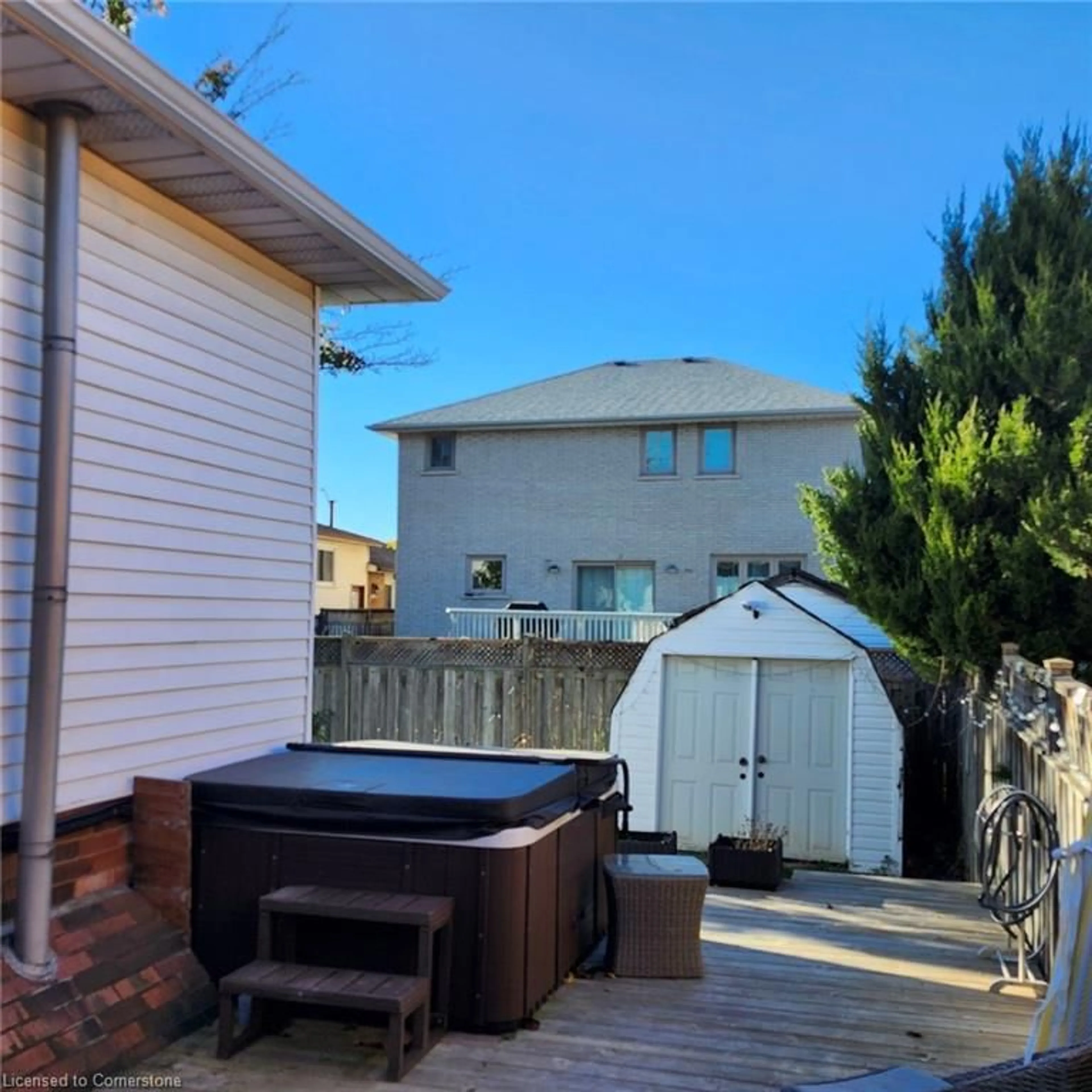 Frontside or backside of a home, the fenced backyard for 18 Rosewell St, Hamilton Ontario L8W 2L1