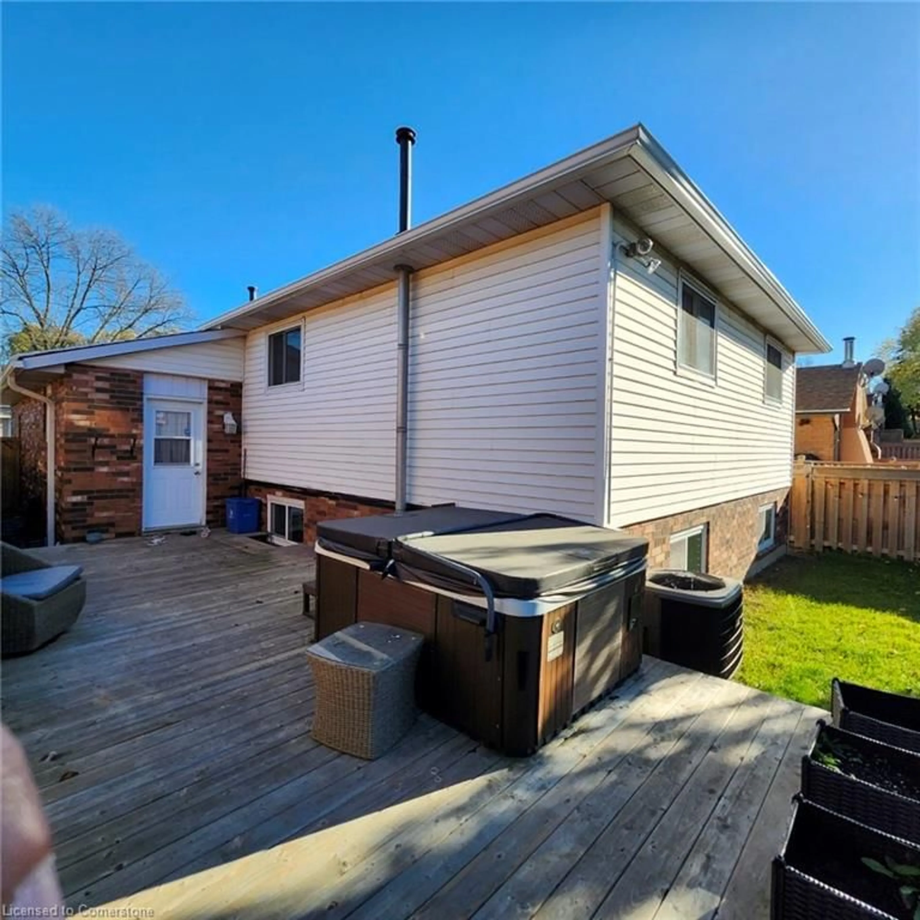 Frontside or backside of a home, the fenced backyard for 18 Rosewell St, Hamilton Ontario L8W 2L1