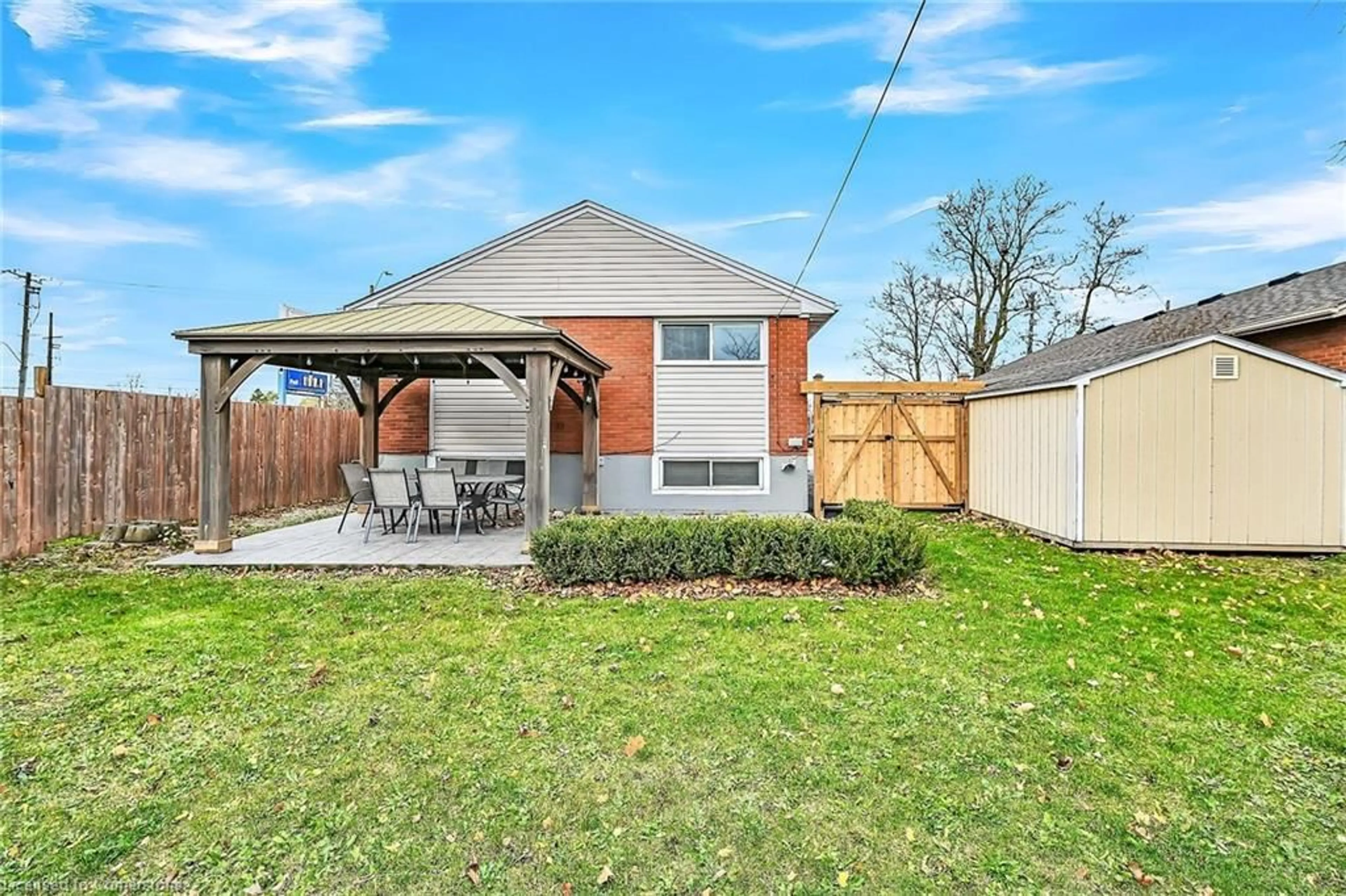 Frontside or backside of a home, the fenced backyard for 787 Upper Ottawa St, Hamilton Ontario L8T 3T8