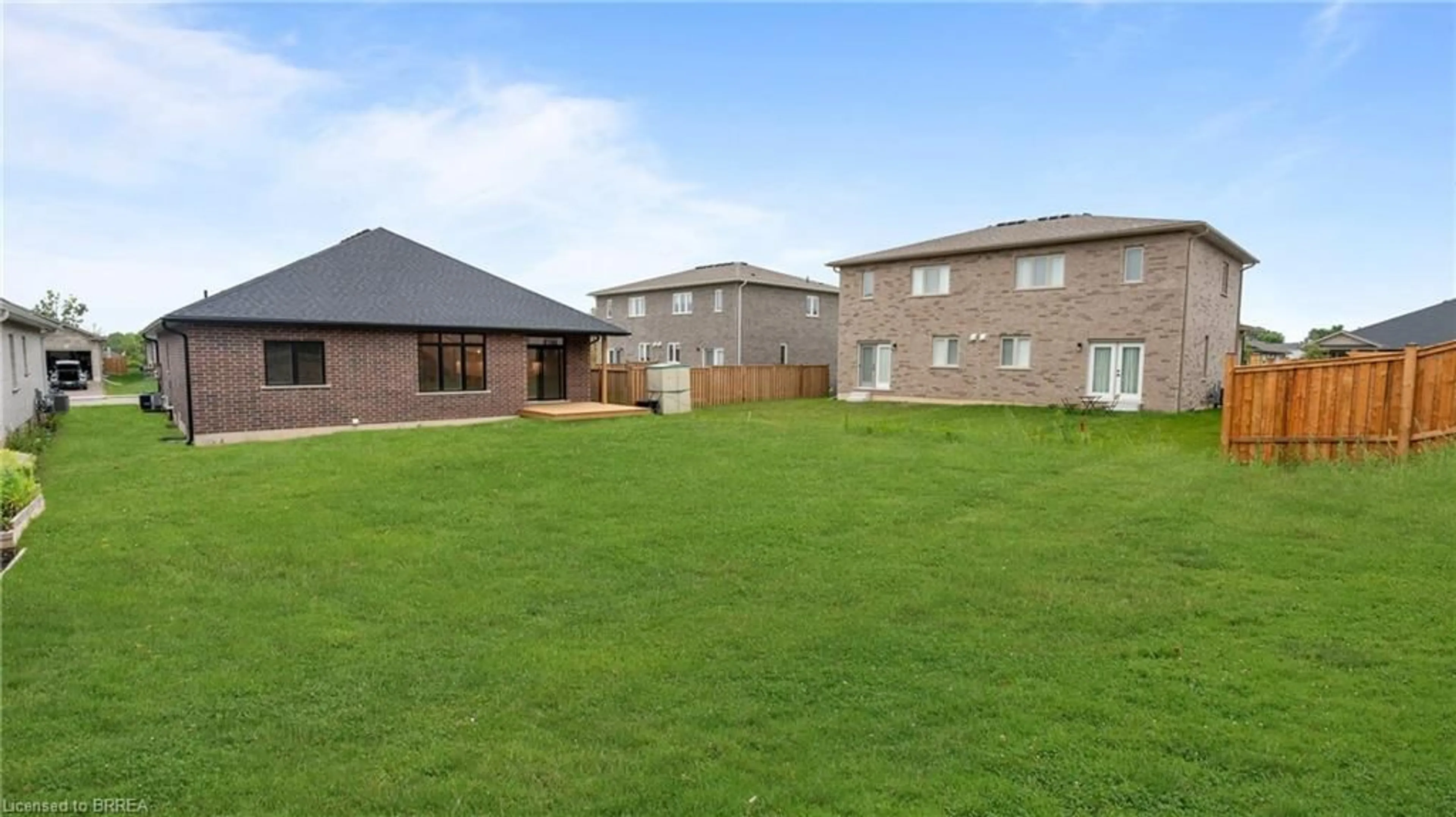 Frontside or backside of a home, the fenced backyard for 45 Vanrooy Trail, Waterford Ontario N0E 1Y0